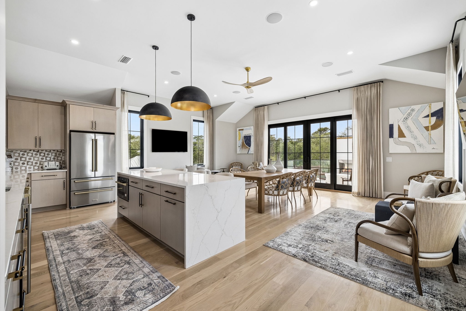 Step into your bright, open living space where modern elegance meets comfort. Sunlight pours through floor-to-ceiling windows, highlighting the sleek kitchen, inviting dining area, and cozy lounge—perfect for memorable moments.