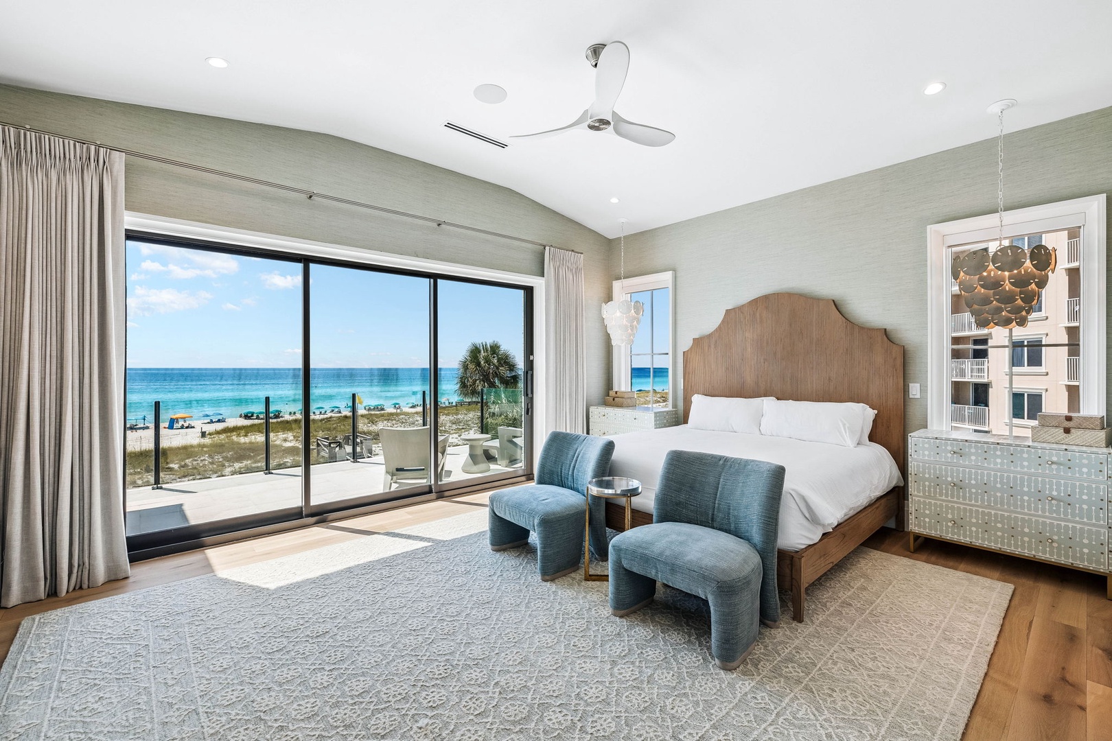 Wake up to stunning ocean views and soft coastal light streaming through expansive windows. Your beachfront bedroom features plush linens, modern furnishings, and direct access to the sand—where relaxation meets the sea.