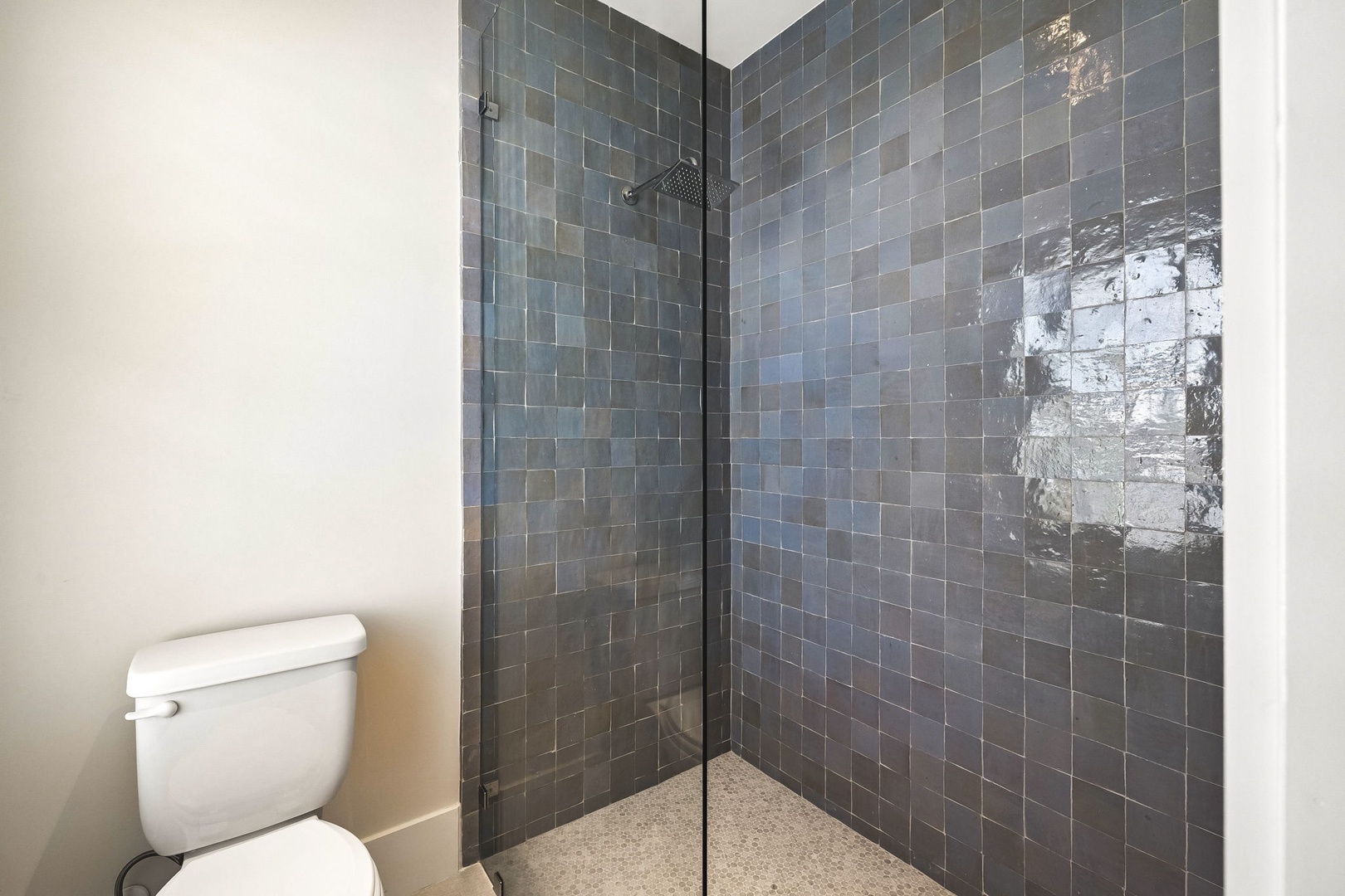 Step into your modern bathroom oasis, where sleek subway tiles and a spacious walk-in shower await. Enjoy refreshing mornings under a rainfall showerhead, surrounded by contemporary design and clean lines.