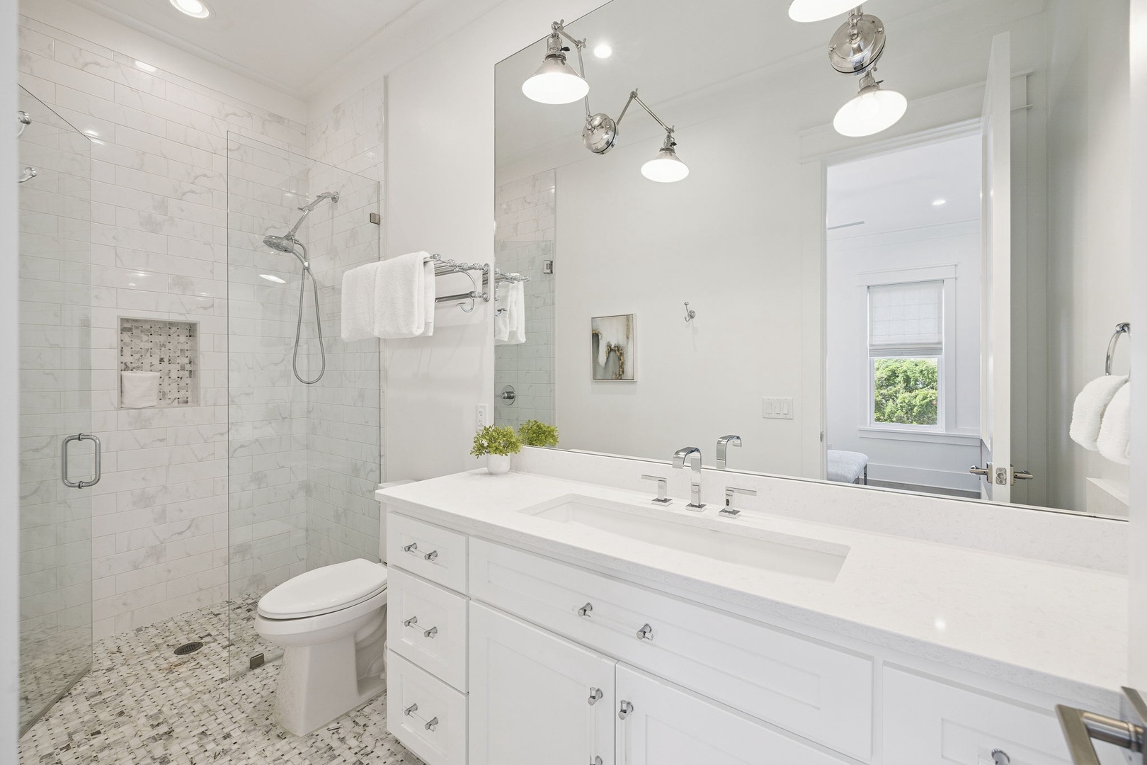 Unwind in your spa-like bathroom with marble counters, glass shower, and crisp white finishes that create a luxurious retreat.