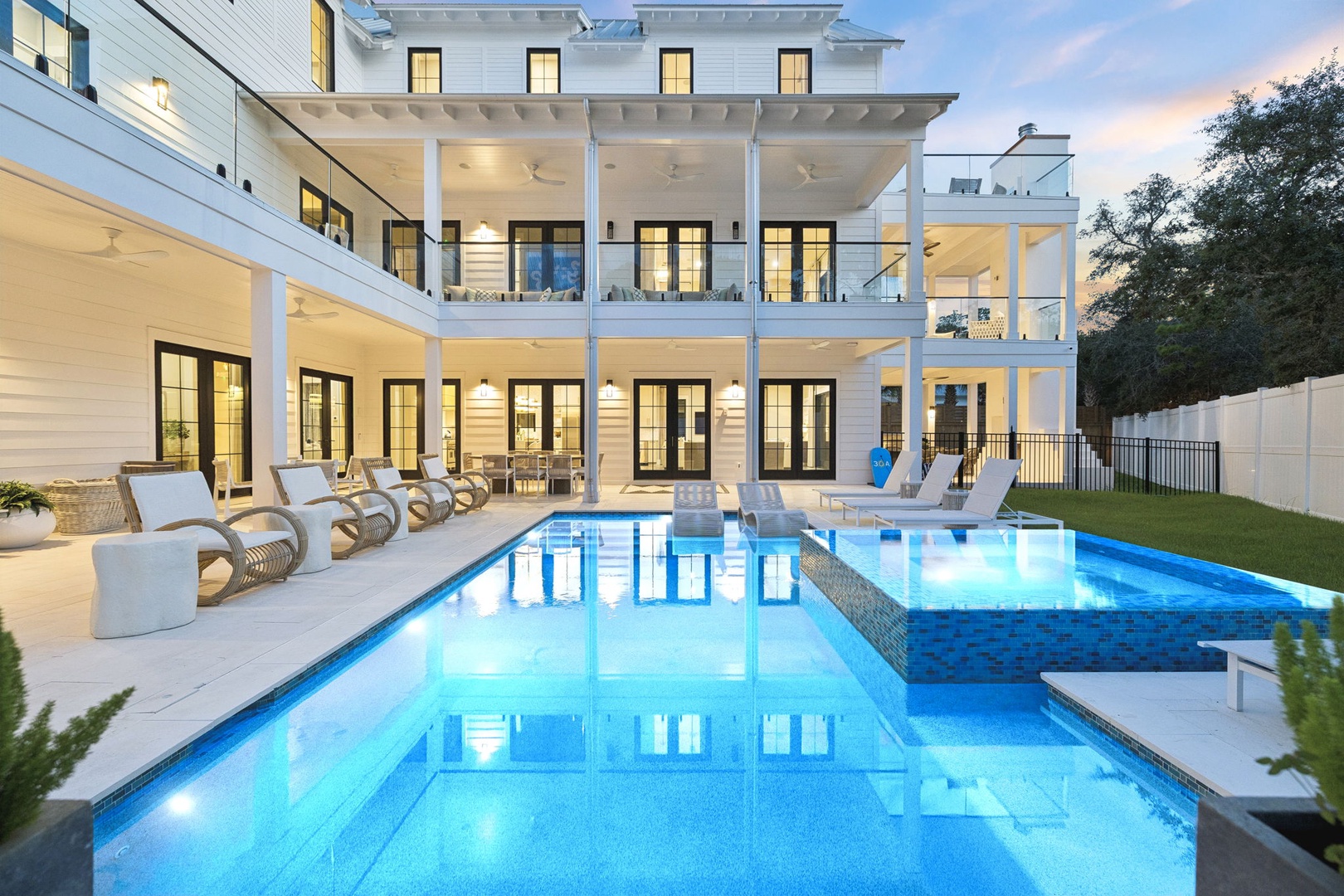 A stunning modern estate showcasing elegant architecture and a sparkling pool area perfect for your next luxurious retreat.