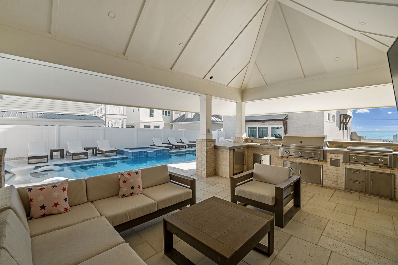 Relax in your private covered patio with plush outdoor seating, overlooking your personal pool and complete outdoor kitchen for memorable gatherings.