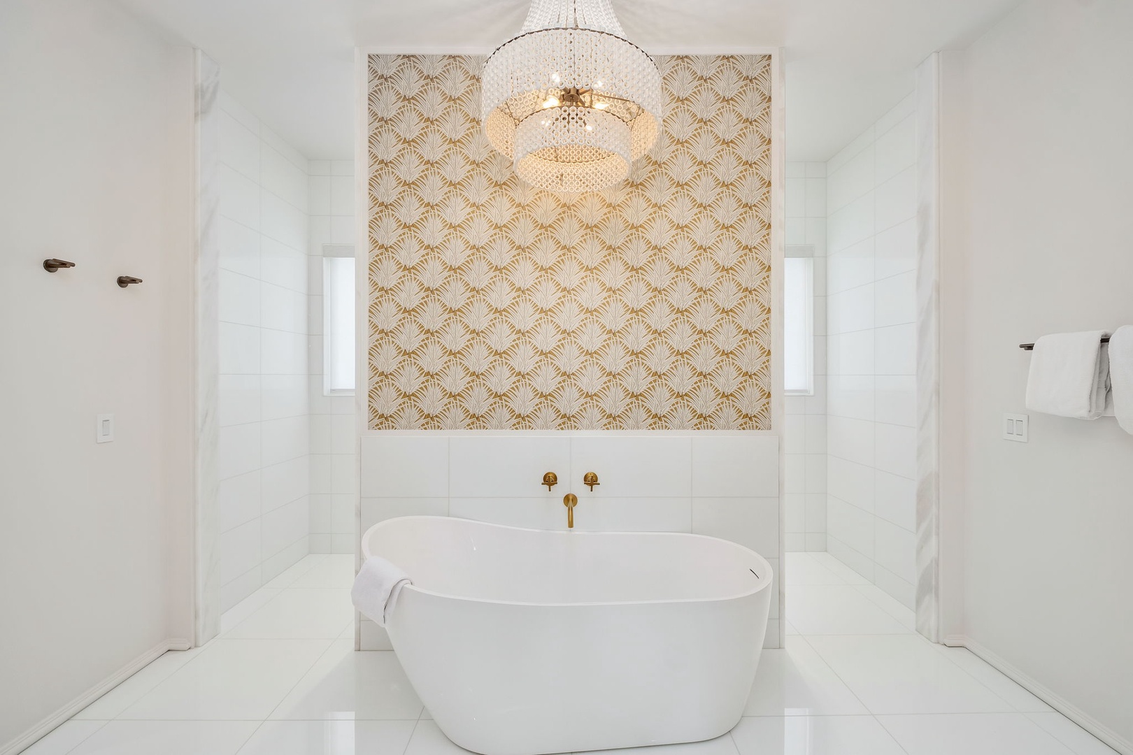 Slip into your private spa-like sanctuary. The elegant soaking tub, sparkling chandelier, and art-deco accents create a serene escape where you can unwind in style.