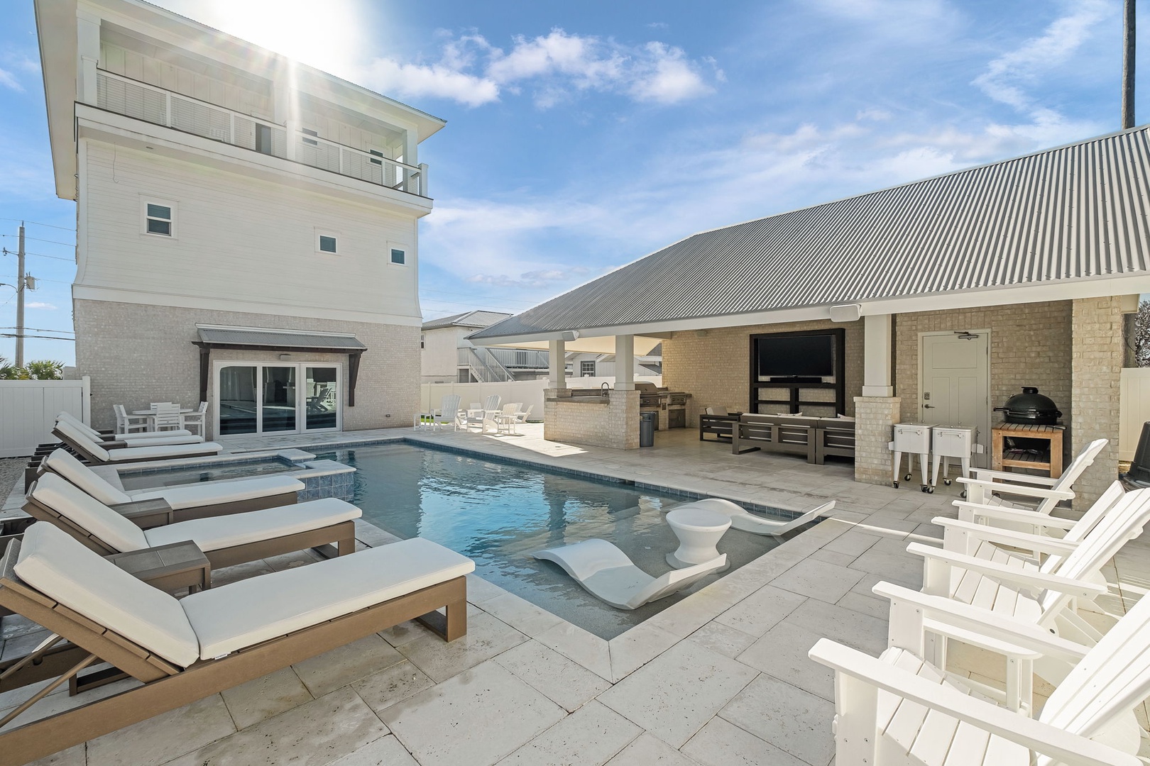 Dive into your private oasis with a sparkling pool, hot tub, and covered outdoor kitchen perfect for entertaining.