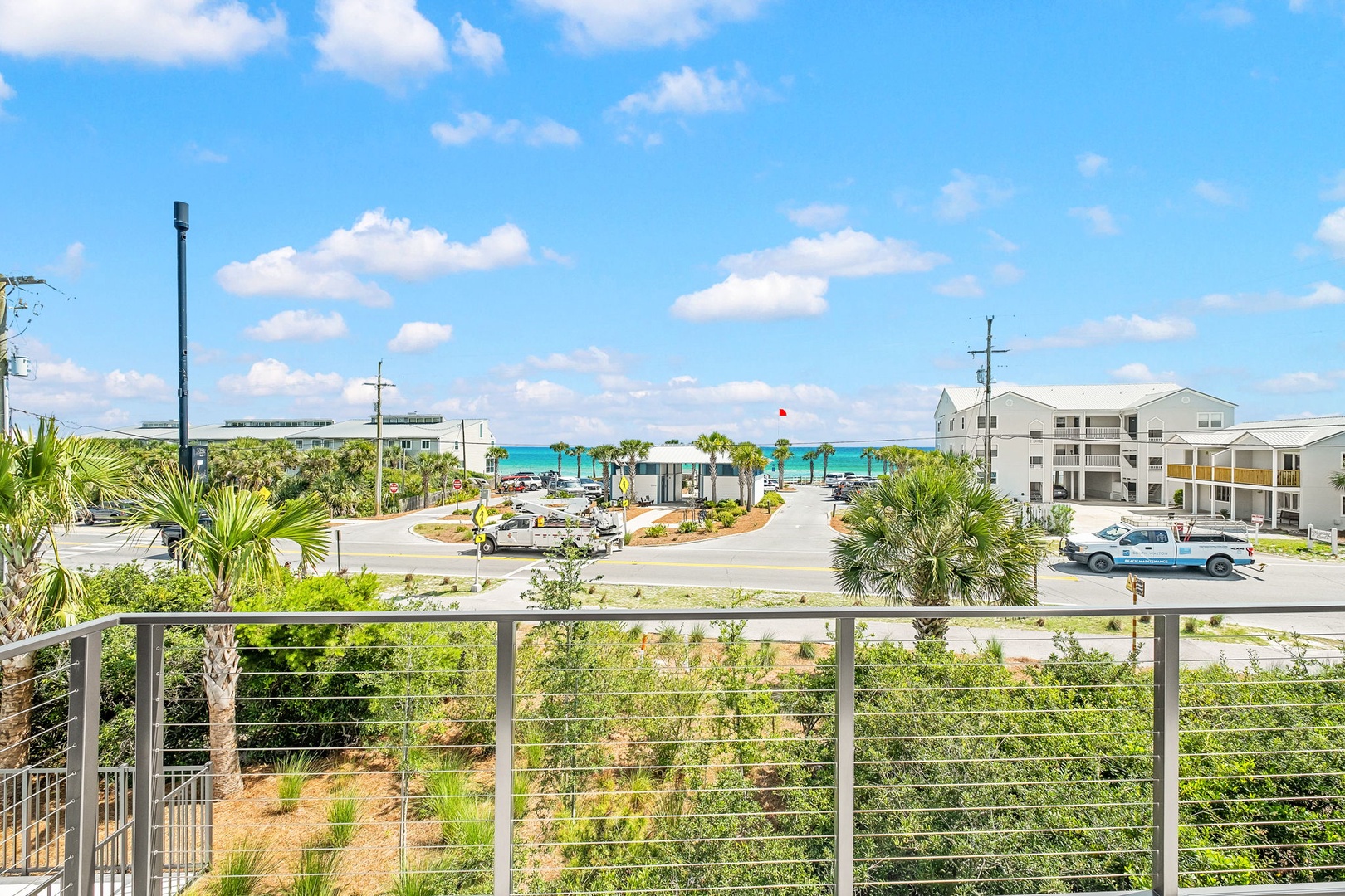 A bright coastal area with palm trees and nearby beach access defines this rental's location. The surrounding neighborhood features tropical landscaping and convenient access to the waterfront.