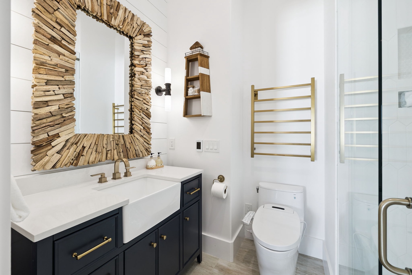 Relax in your spa-like bathroom featuring a stunning driftwood mirror, heated towel racks, and modern amenities.