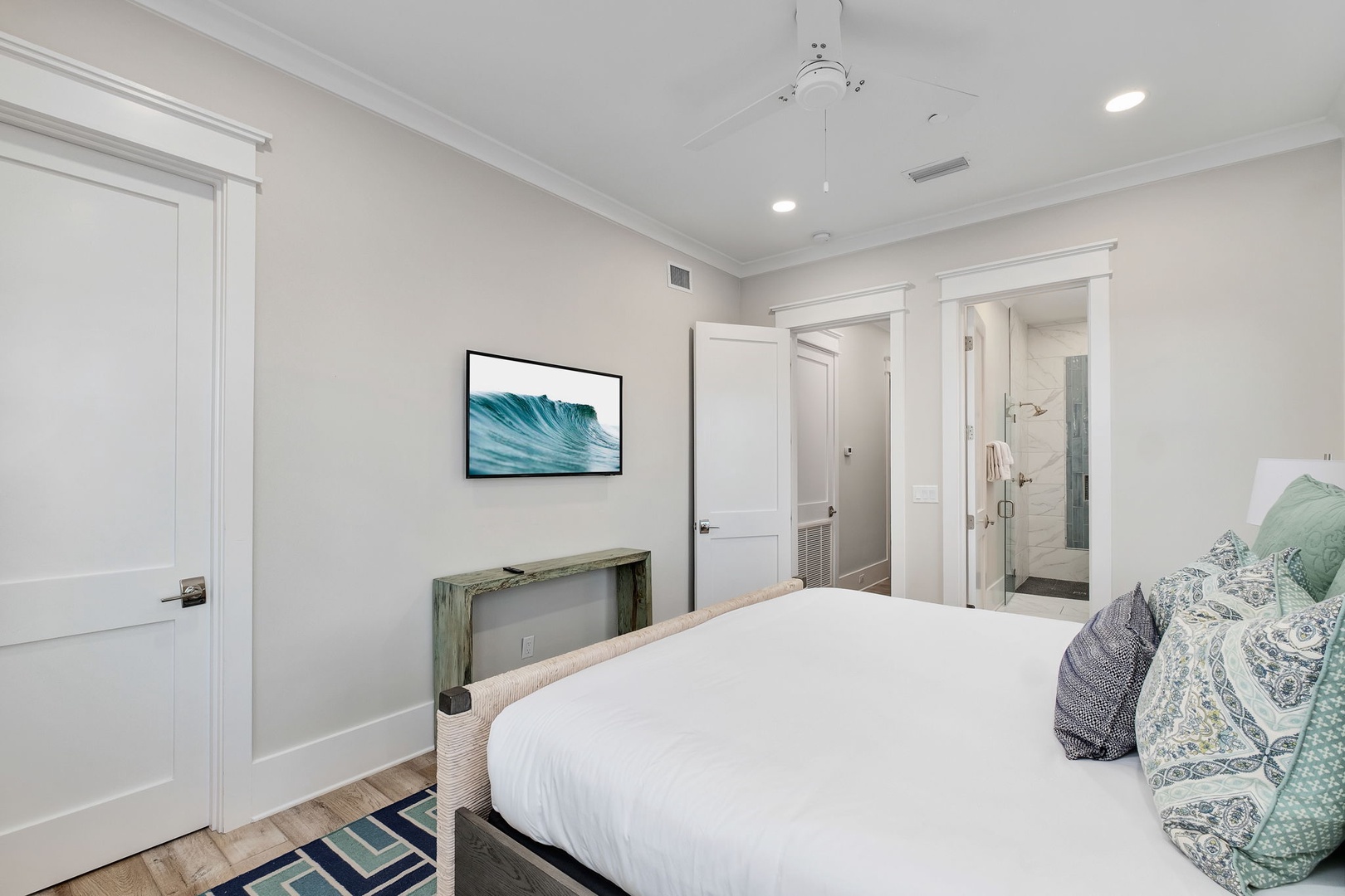 Your peaceful bedroom features fresh linens, coastal artwork, and an ensuite bathroom for complete comfort and privacy.