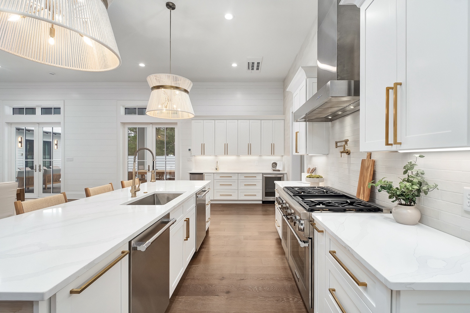 Your gourmet kitchen awaits with marble countertops, brass accents, and premium appliances perfect for culinary adventures.