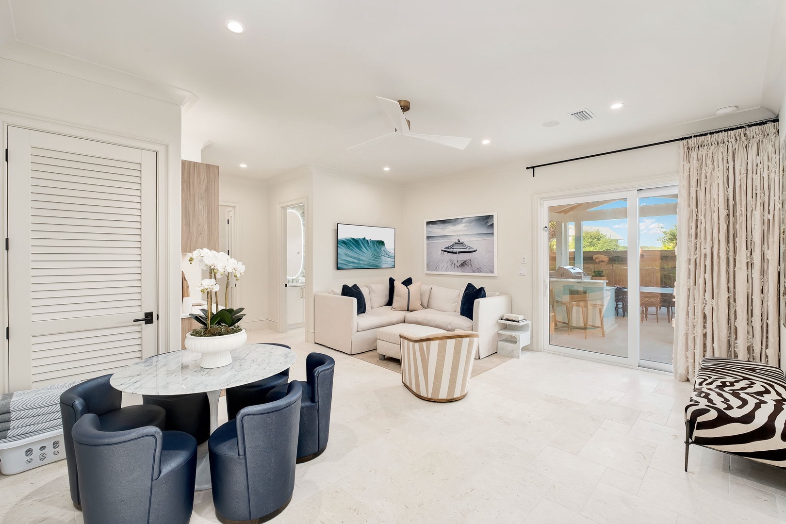 Step into your bright, open living space with coastal artwork, plush seating, and seamless patio access—perfect for relaxing after exploring nearby adventures.