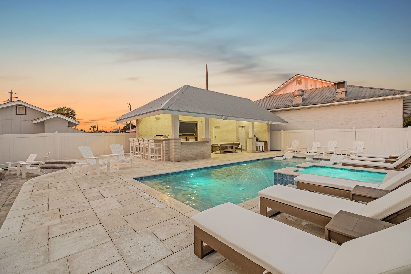 Stunning poolside retreat with heated spa, outdoor kitchen, and luxury loungers—perfect for sunset gatherings with friends and family.