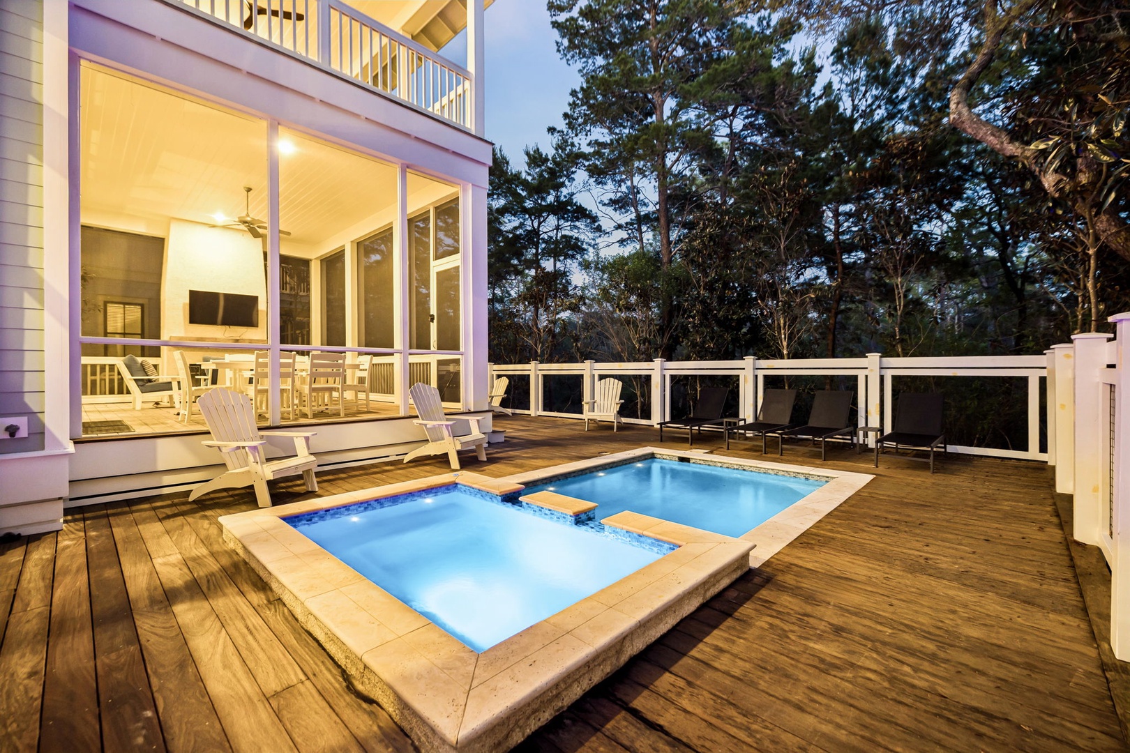 Your private deck oasis awaits with heated pools and cozy lounge chairs under the evening sky.