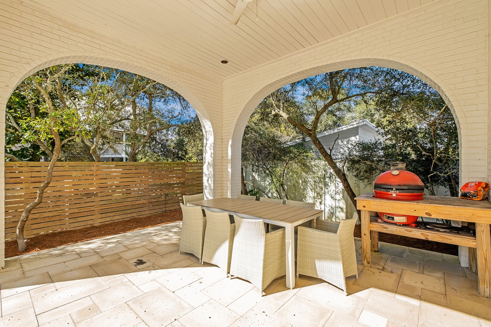 Dine al fresco under elegant arches where your outdoor kitchen awaits with premium barbecue setup, perfect for memorable meals.