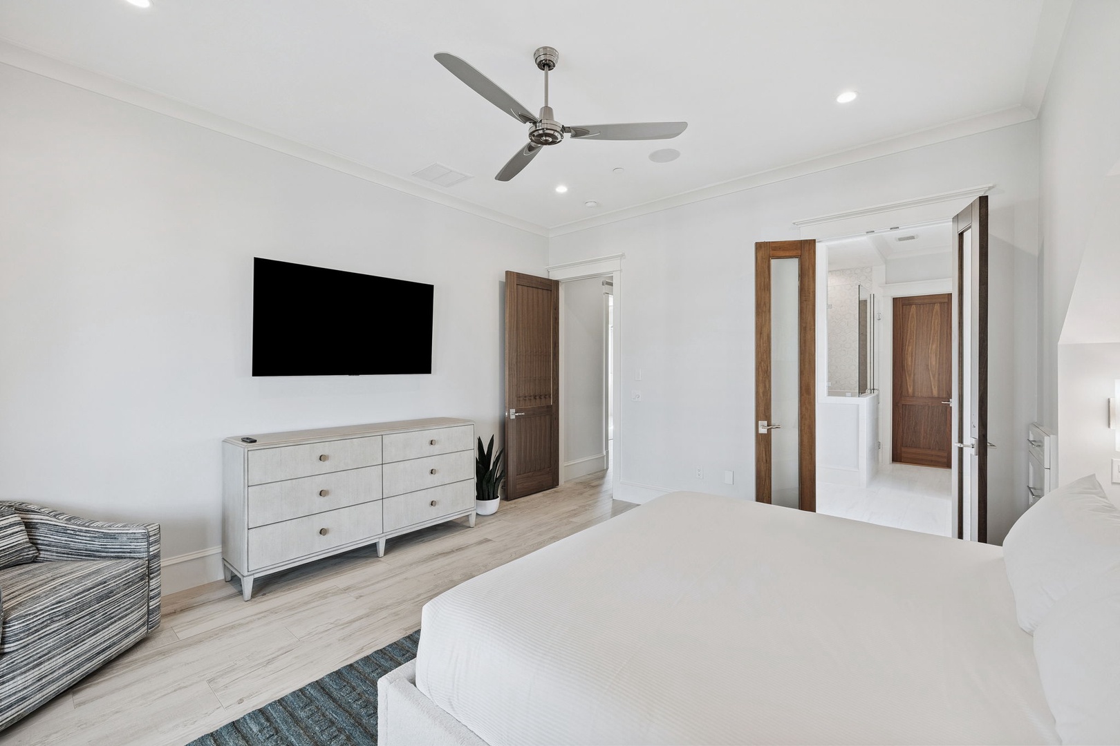 Unwind in your serene retreat with crisp white linens, modern entertainment, and peaceful atmosphere.