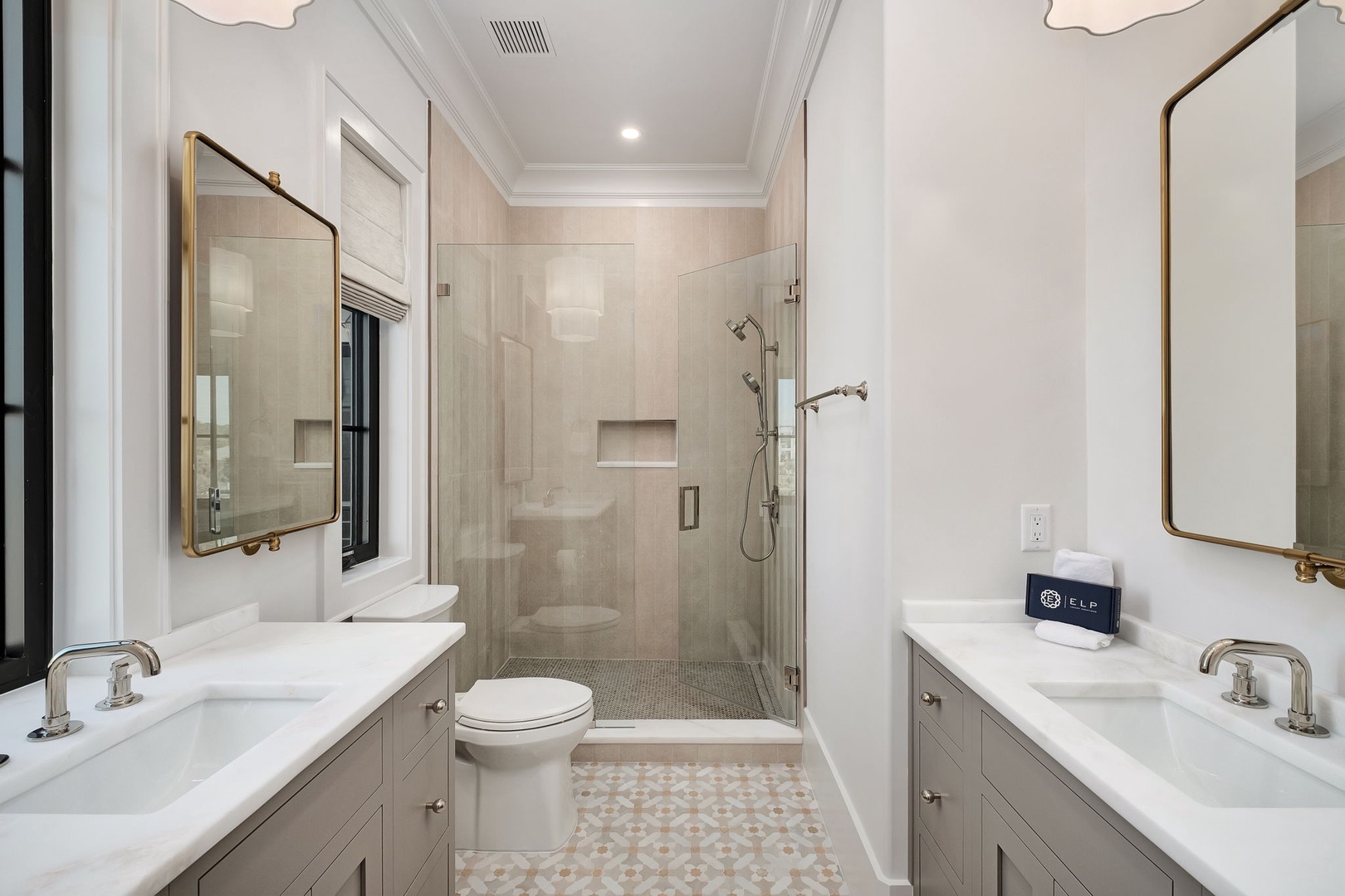 Luxurious master bathroom with dual vanities, marble countertops, and spacious walk-in shower for your comfort.