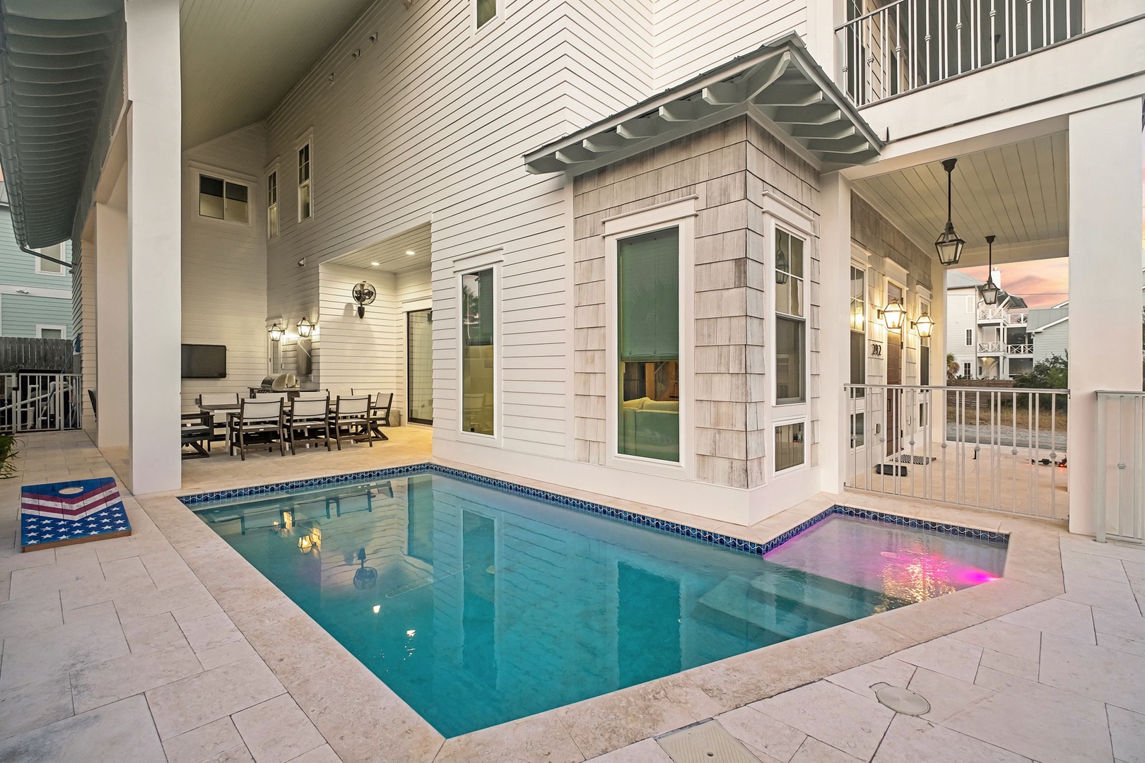 Your private pool awaits with warm lighting and covered dining, creating the perfect evening retreat for relaxation.
