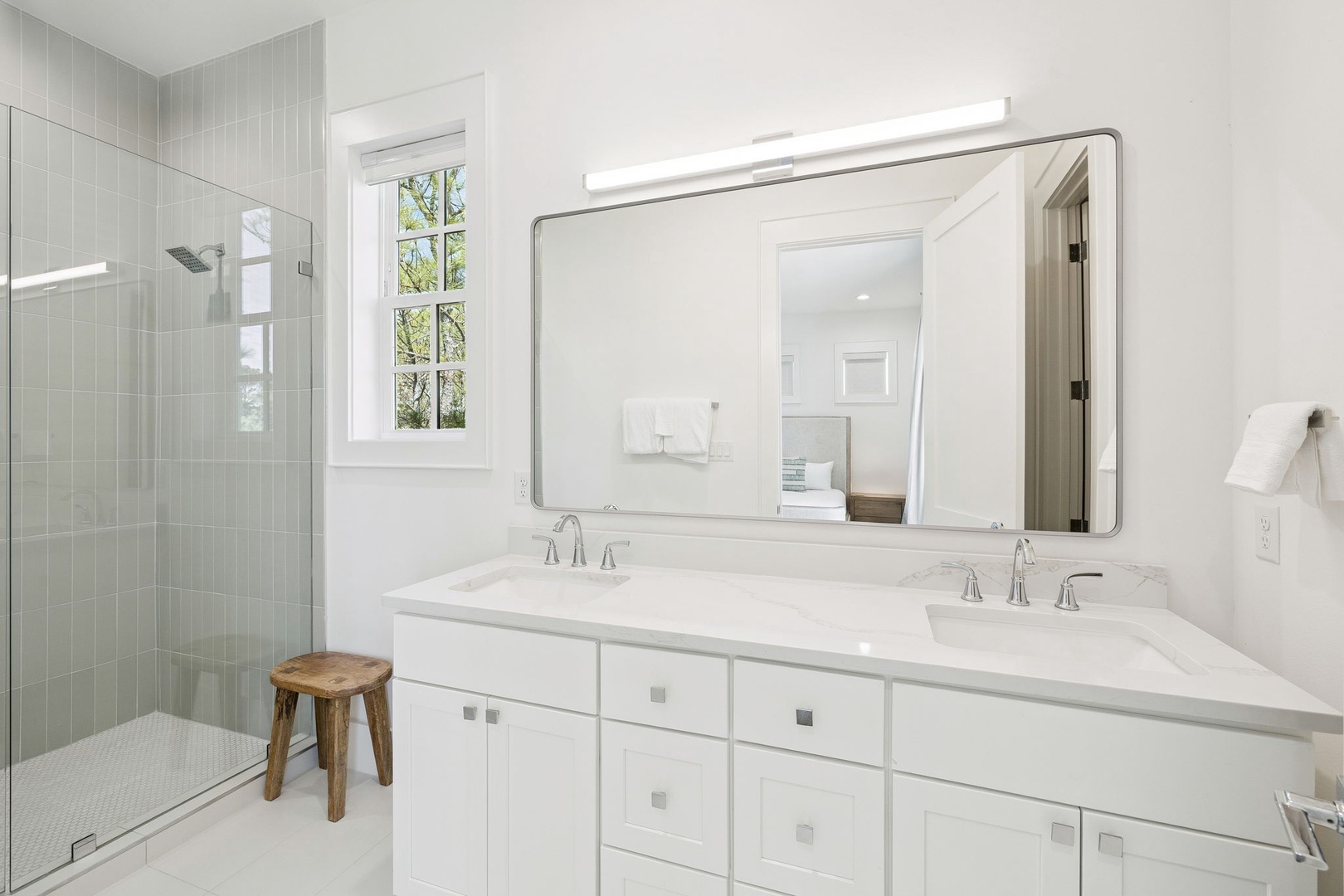 Step into your serene bathroom oasis with dual vanities, marble countertops, and a luxurious glass-enclosed shower—your perfect retreat after a day of adventures.