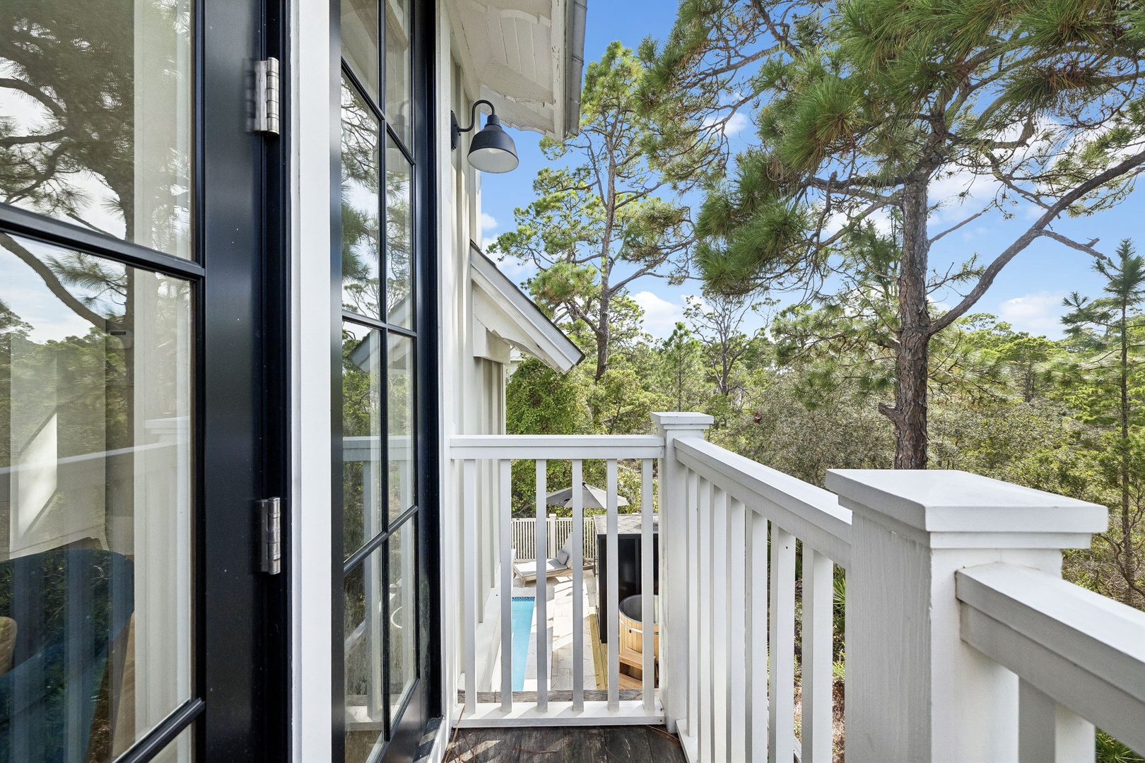 Step onto your private balcony and breathe in the fresh pine-scented air. With towering trees all around and a glimpse of the pool below, this peaceful spot invites you to unwind and soak in the natural beauty surrounding your retreat.