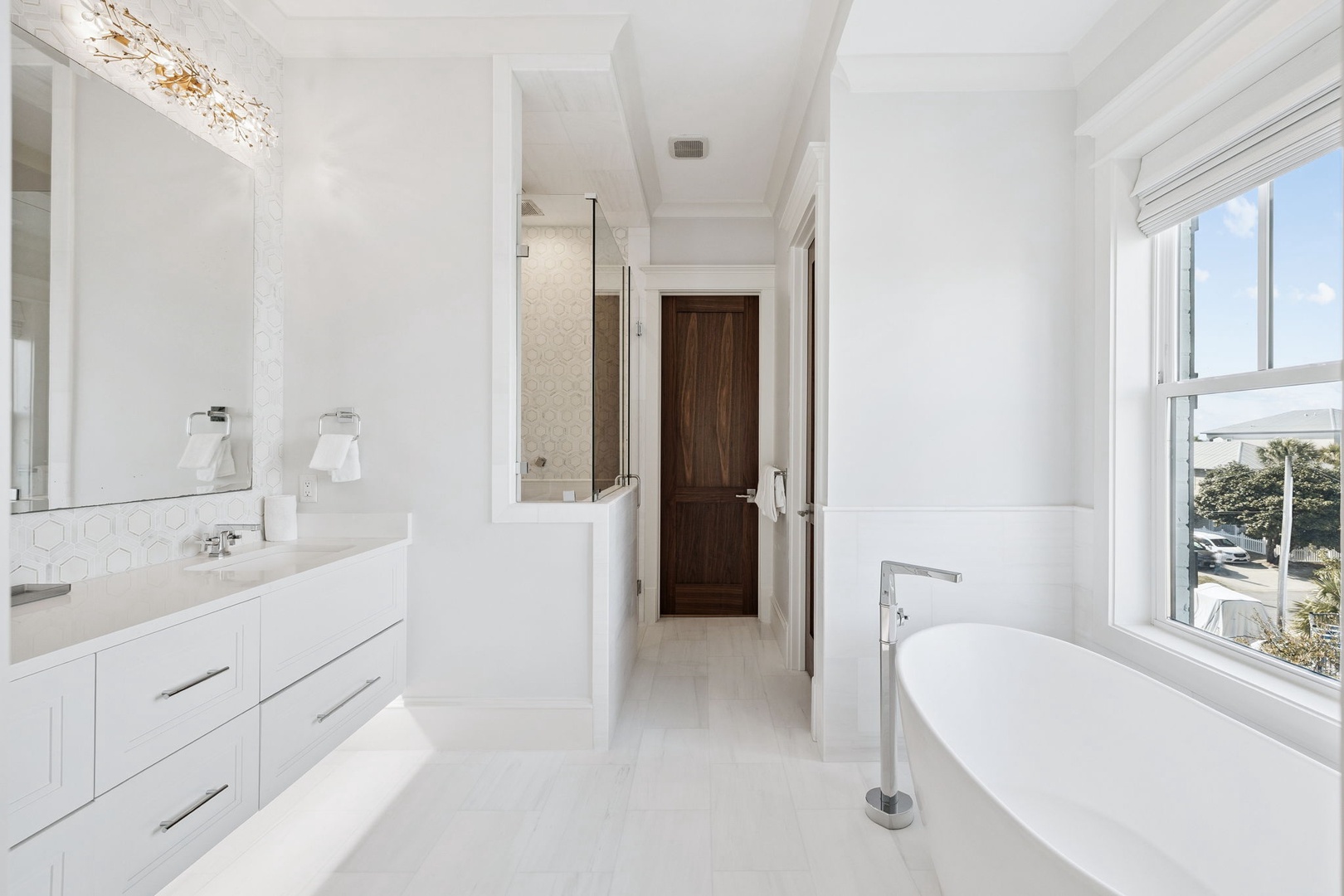 Unwind in your spa-like bathroom with gleaming marble surfaces, a soaking tub, and elegant vanity perfect for your morning routine.