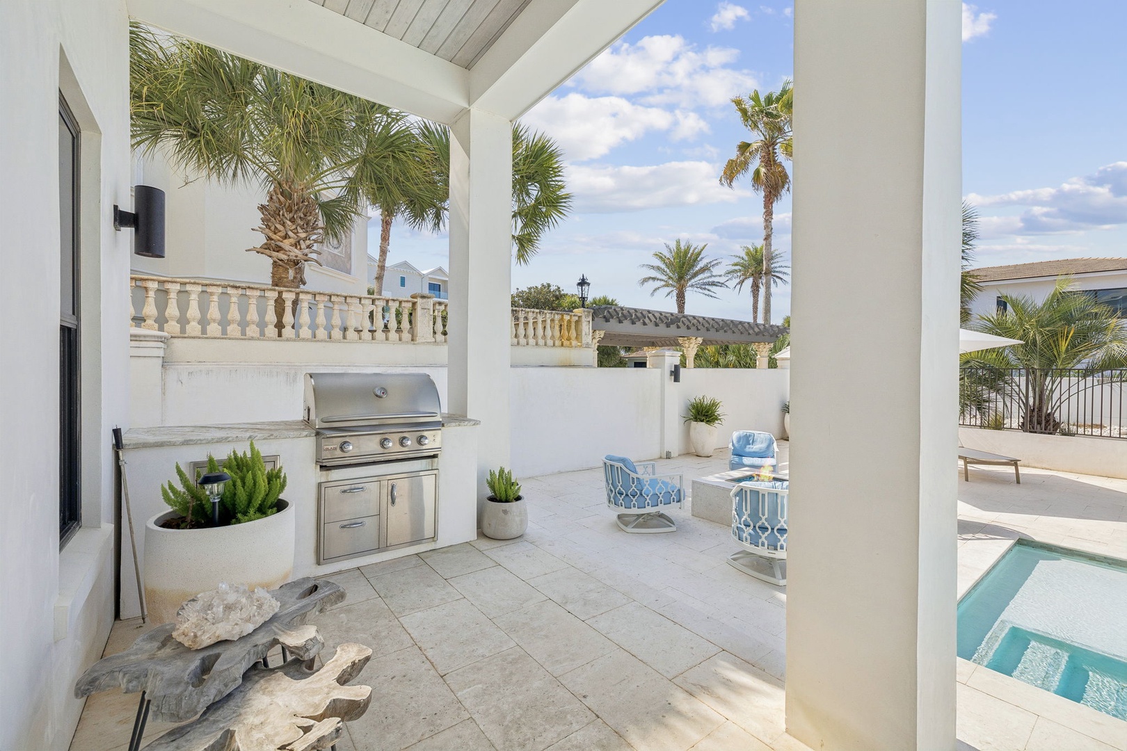 Your covered patio offers the perfect outdoor retreat with a built-in grill for beachside barbecues and pool views.