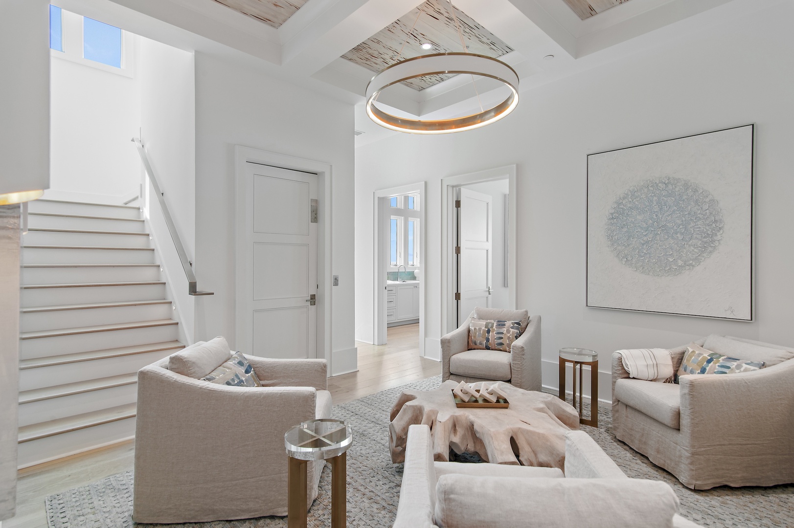 Sink into plush seating beneath soaring ceilings with skylights that flood your living room with natural light. The soft neutrals and coastal-inspired accents create a serene retreat for your stay.