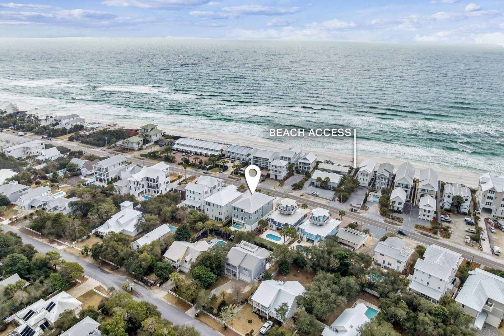 Aerial view of beachfront vacation rental community with direct beach access and pristine white sand coastline.