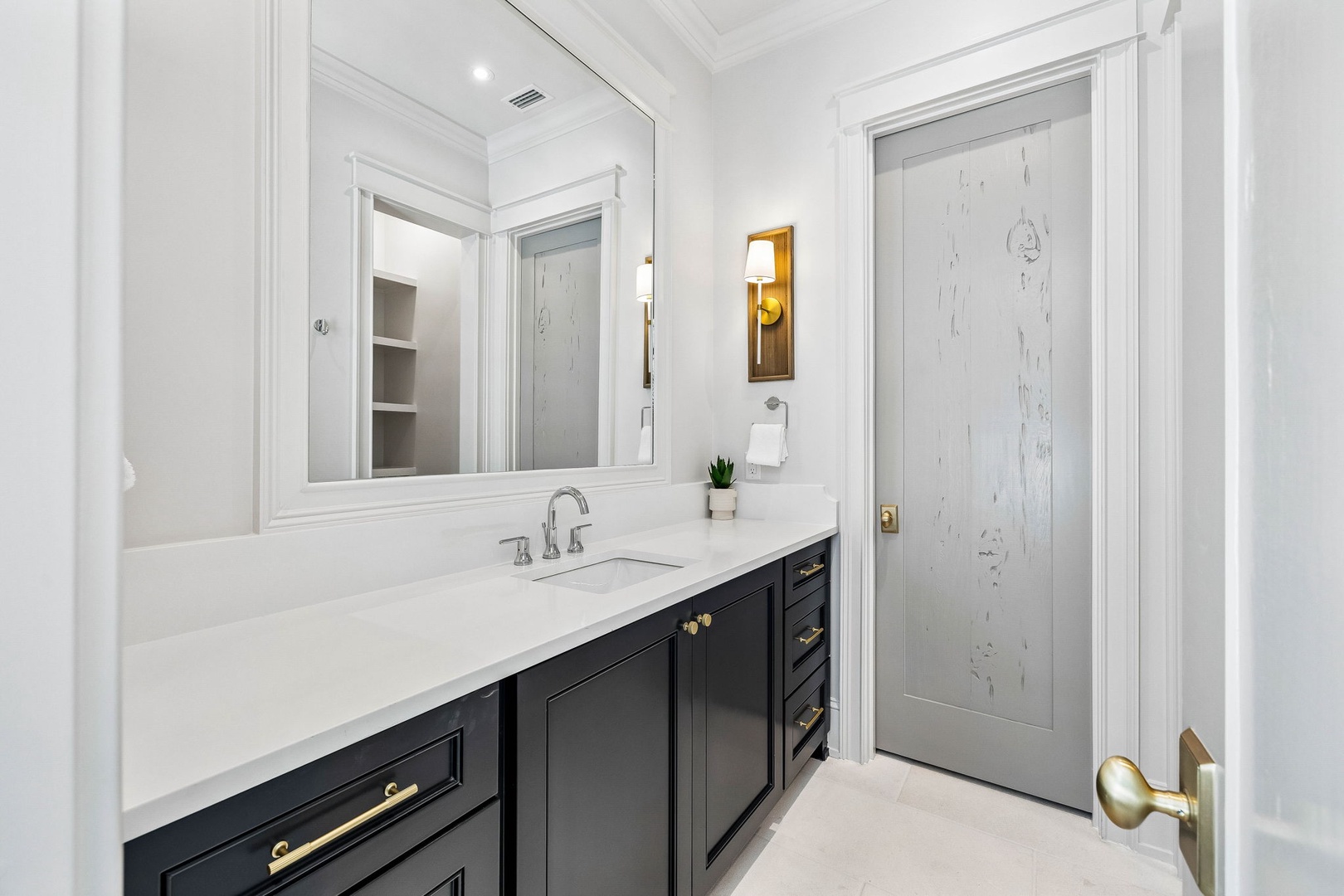 Step into your elegant private bathroom with marble-veined finishes, polished brass accents, and a spacious vanity that makes your morning routine feel luxurious.