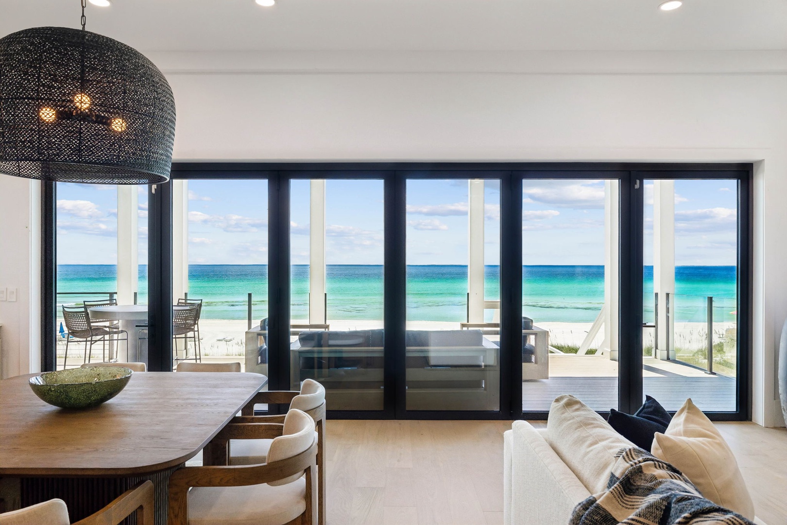 Step inside and let the turquoise waters fill your view. Floor-to-ceiling glass doors frame the beach, inviting you to relax in bright, airy comfort just steps from the sand.