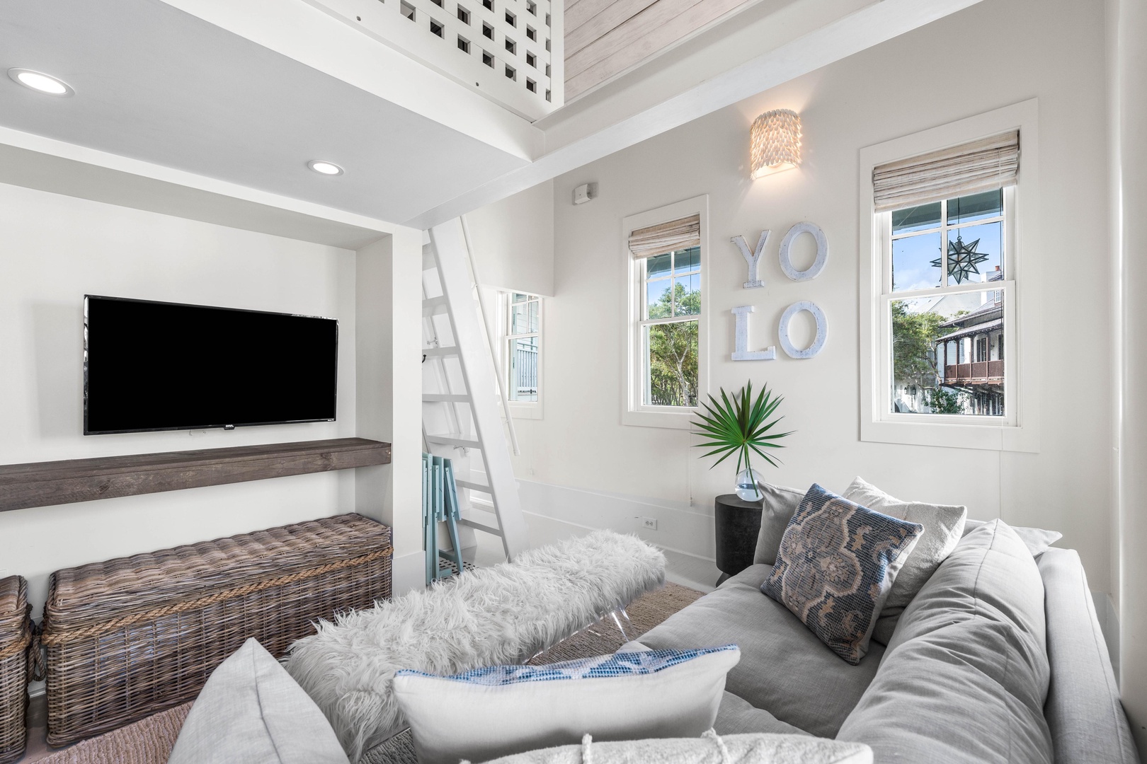 Sink into plush seating beneath soaring ceilings and beam accents. Your bright, airy retreat features a cozy TV area perfect for unwinding.