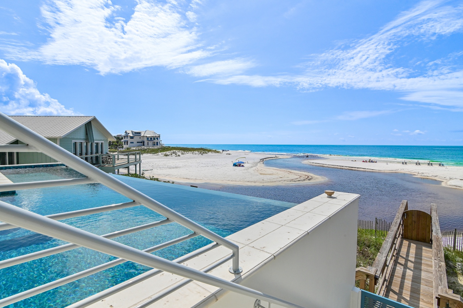 Stunning views await just beyond your balcony, where turquoise waves meet soft sand and a sparkling pool invites you to relax under endless blue skies.