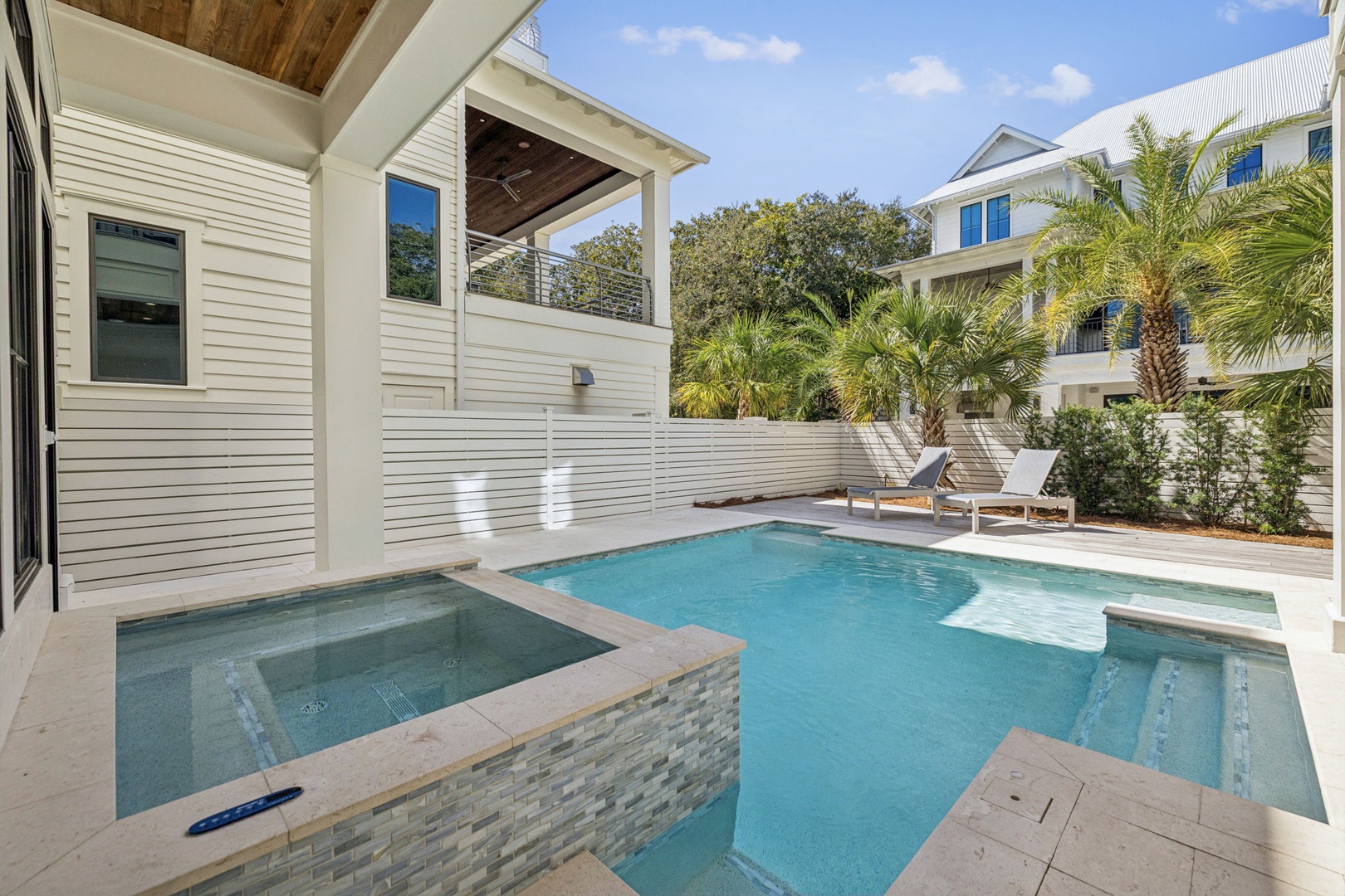 Your private pool and spa await, surrounded by tropical palms and modern comfort for the perfect vacation escape.