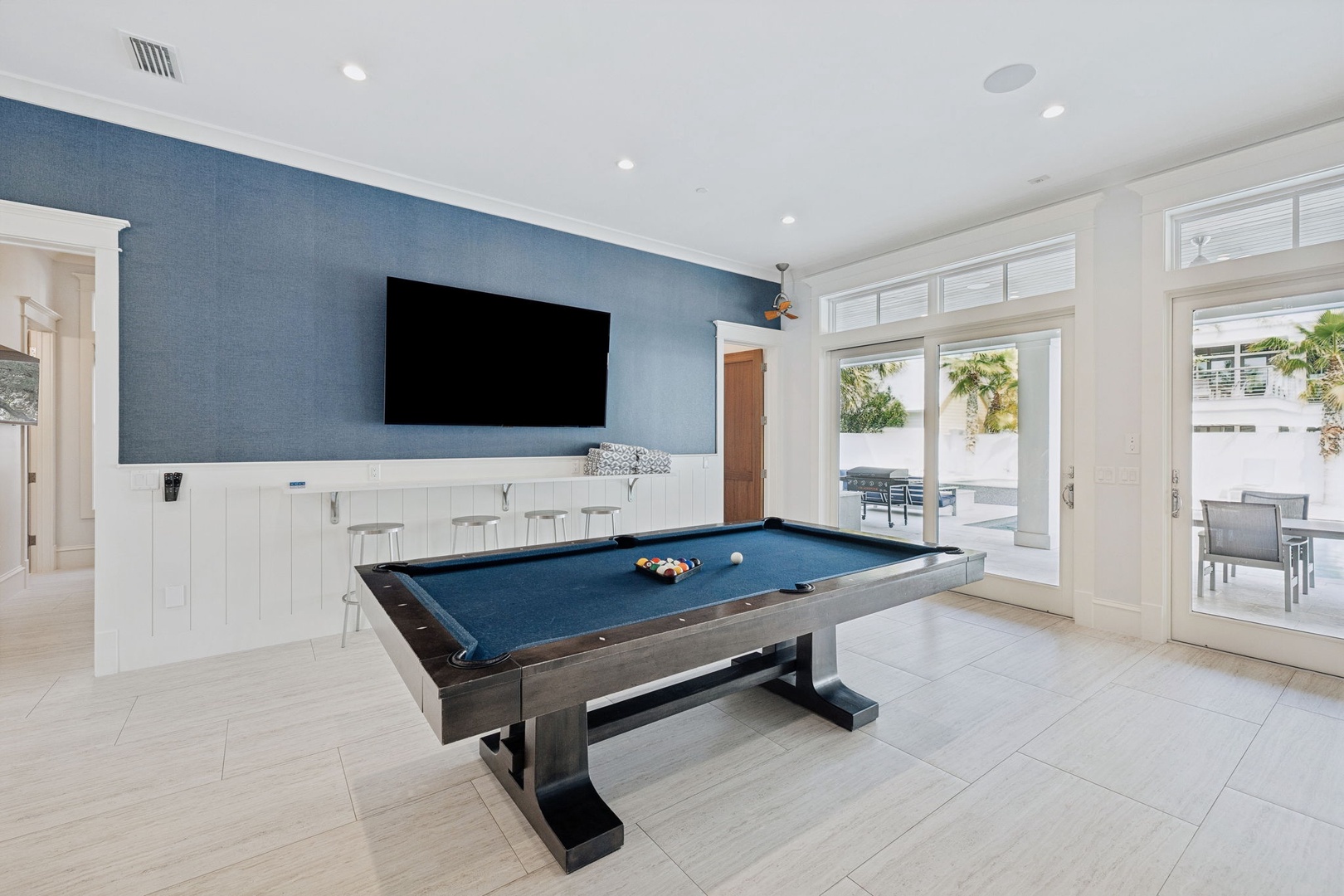 Your private game room awaits with a sleek pool table and mounted TV, perfect for friendly competitions and relaxing evenings.