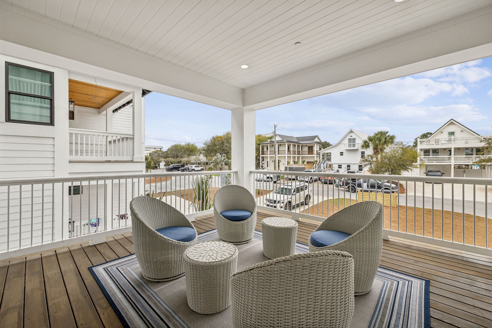 Relax with your morning coffee in this breezy wicker seating area, where coastal comfort meets neighborhood charm.