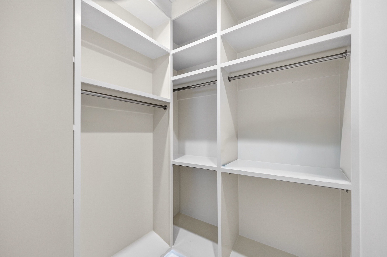 Generous walk-in closet with custom shelving and hanging rods keeps your belongings perfectly organized during your stay.