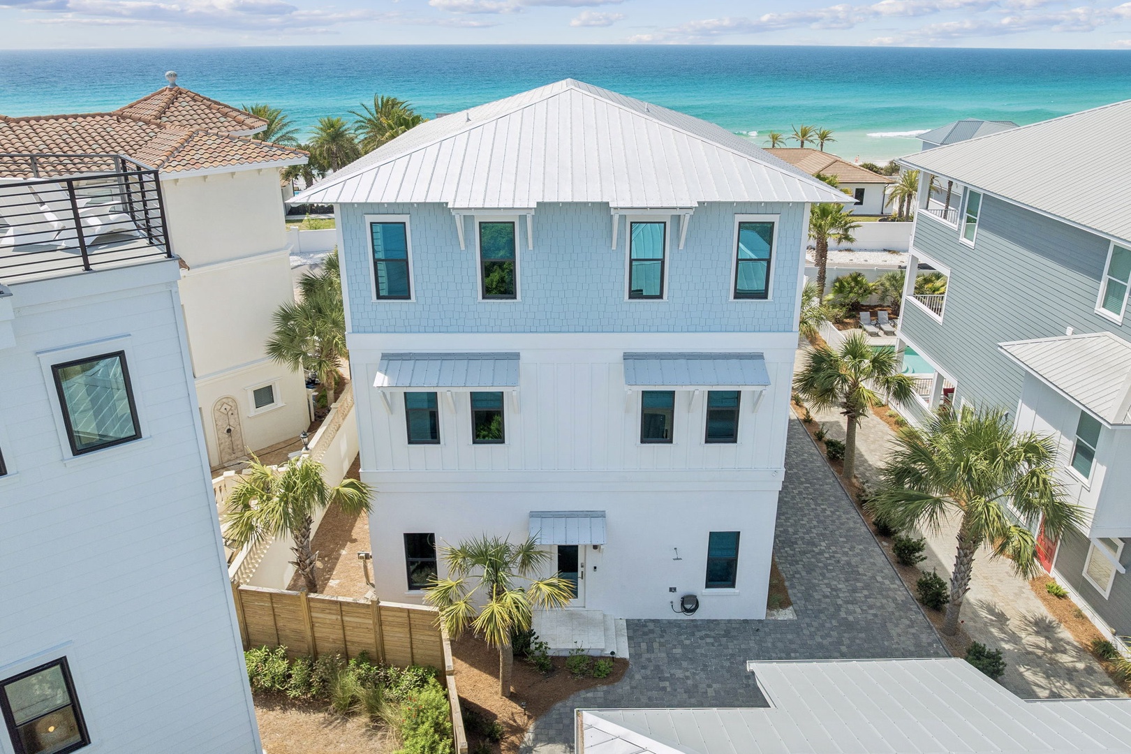 Modern coastal architecture positioned just steps from pristine turquoise waters and white sand beaches.