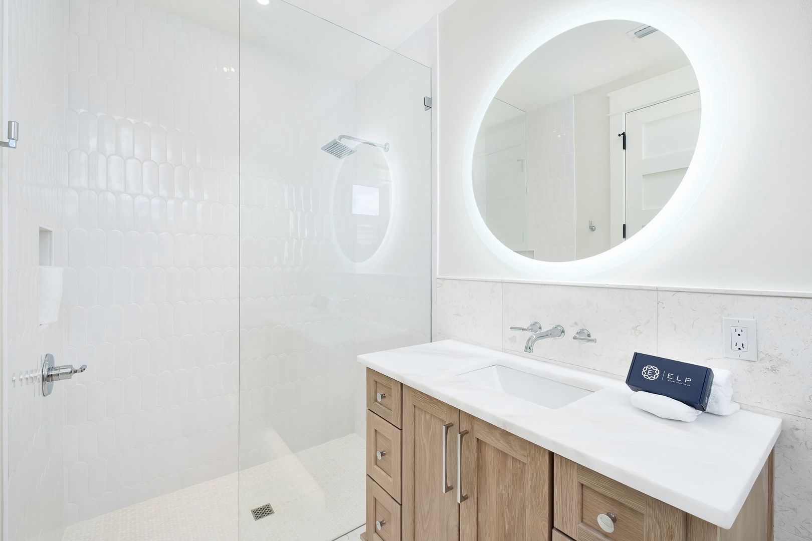 Step into your bright, modern bathroom with a sleek walk-in shower and stylish backlit mirror that creates a spa-like atmosphere for your morning routine.