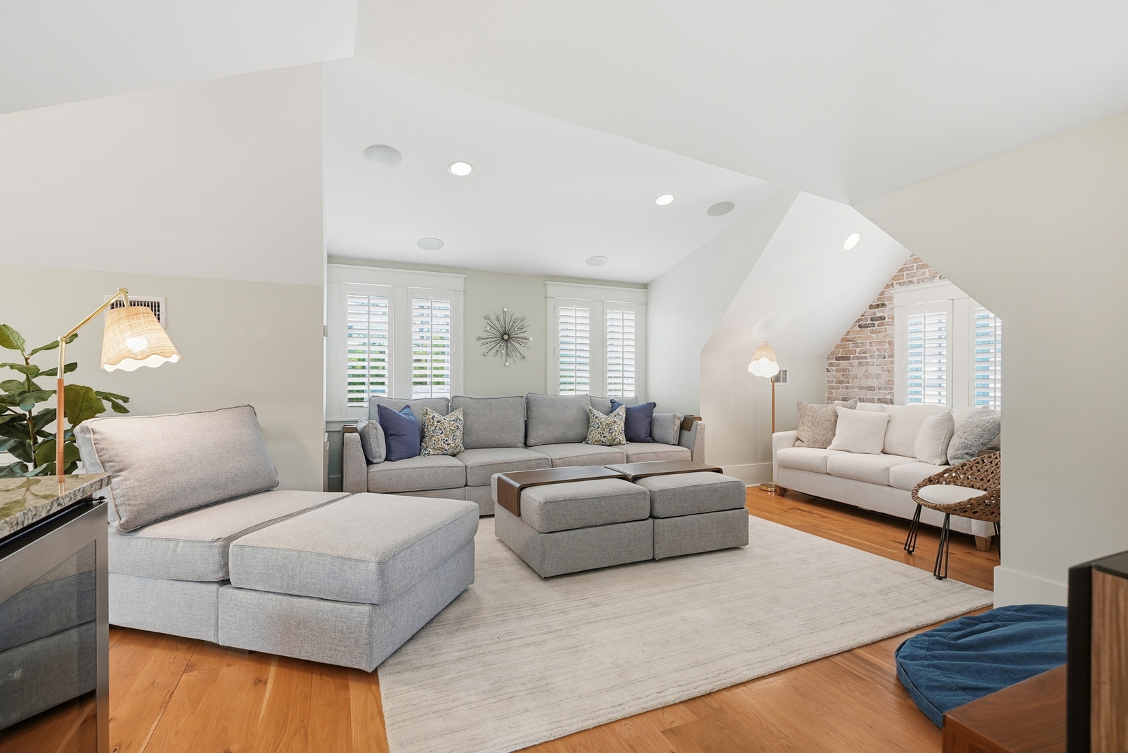 Sink into cozy seating under vaulted ceilings with plantation shutters filtering soft light—your perfect space to unwind after exploring the area.