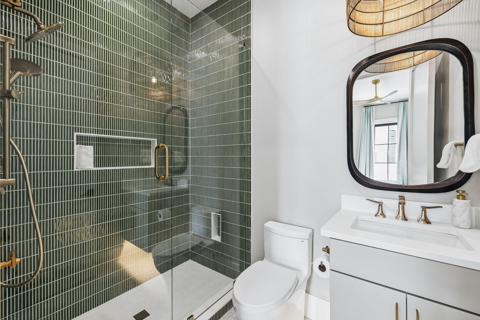 Step into your serene spa-like bathroom, where rich green tile and warm brass fixtures create a calming oasis for your morning routine.