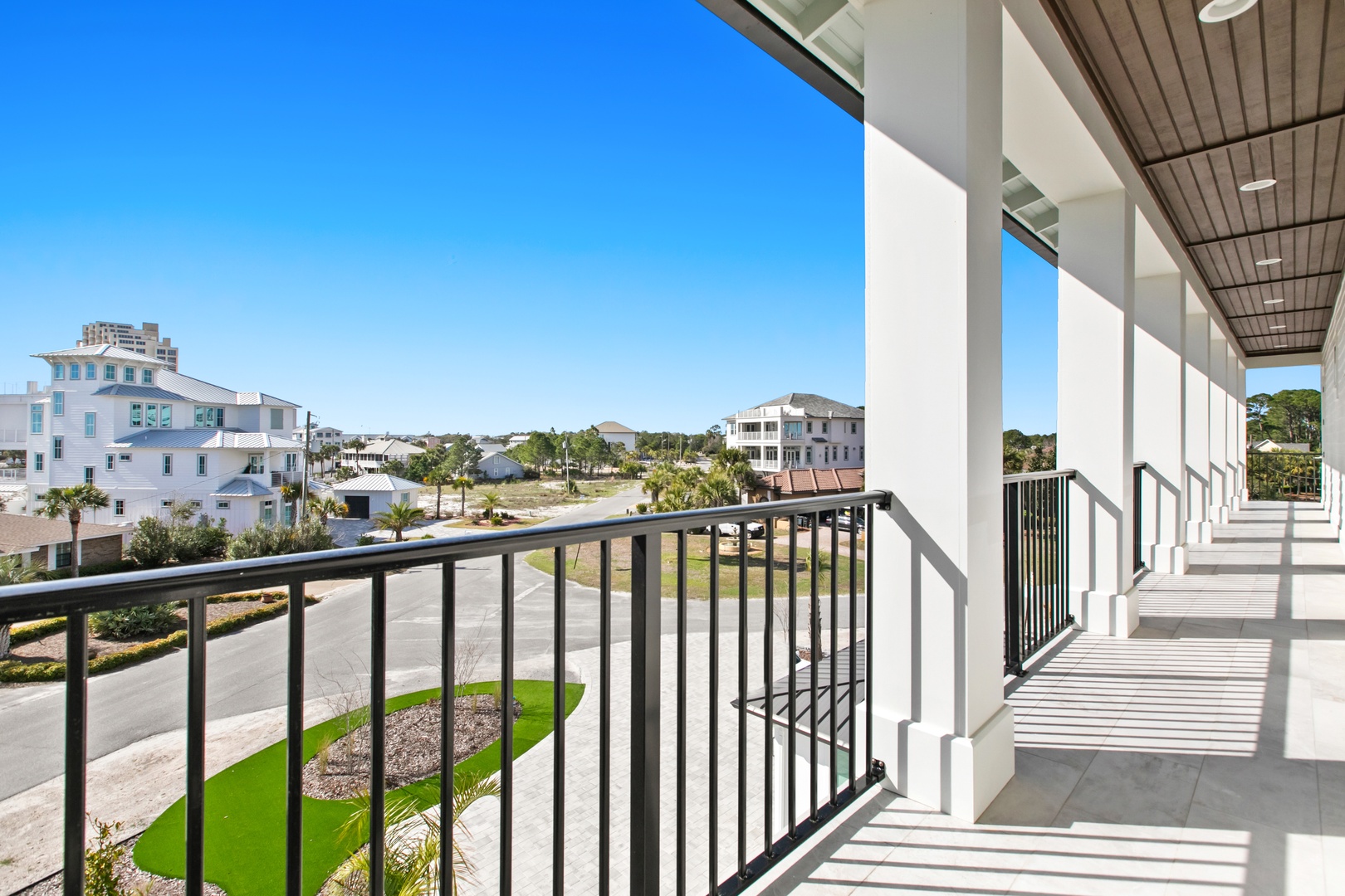 Step onto your private balcony and soak in the open coastal neighborhood views under a bright blue sky—perfect for morning coffee or evening relaxation.