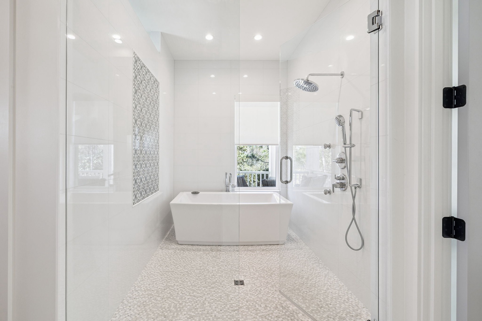 Step into your private spa-like sanctuary featuring a luxurious soaking tub and rainfall shower with elegant mosaic accents.