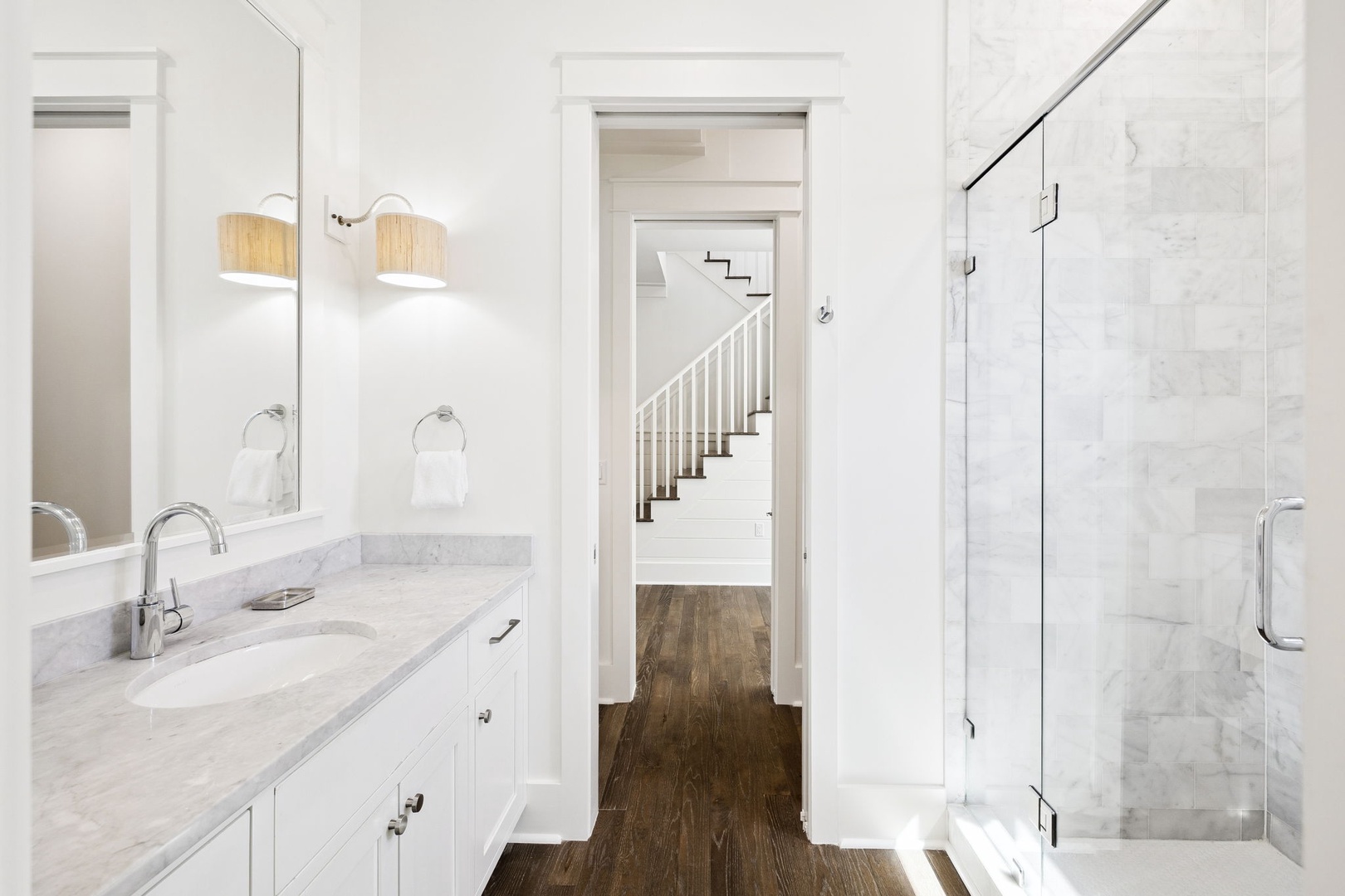 Unwind in your marble sanctuary with dual vanities, rainfall shower, and warm wood accents creating the perfect spa-like retreat.