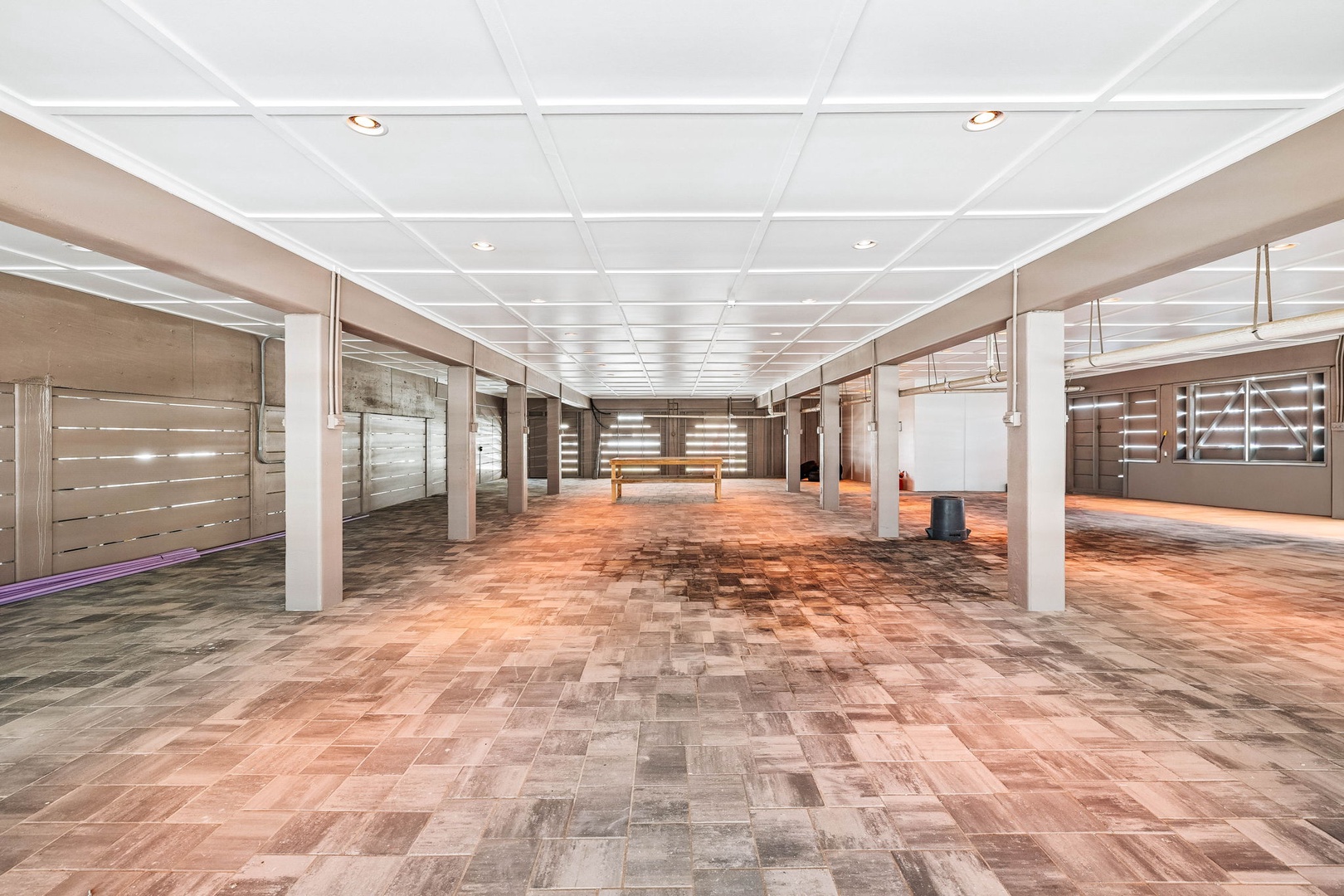 A spacious multi-purpose area awaits your gatherings with beautiful hardwood flooring, modern lighting, and an open layout that can be customized for events or activities.