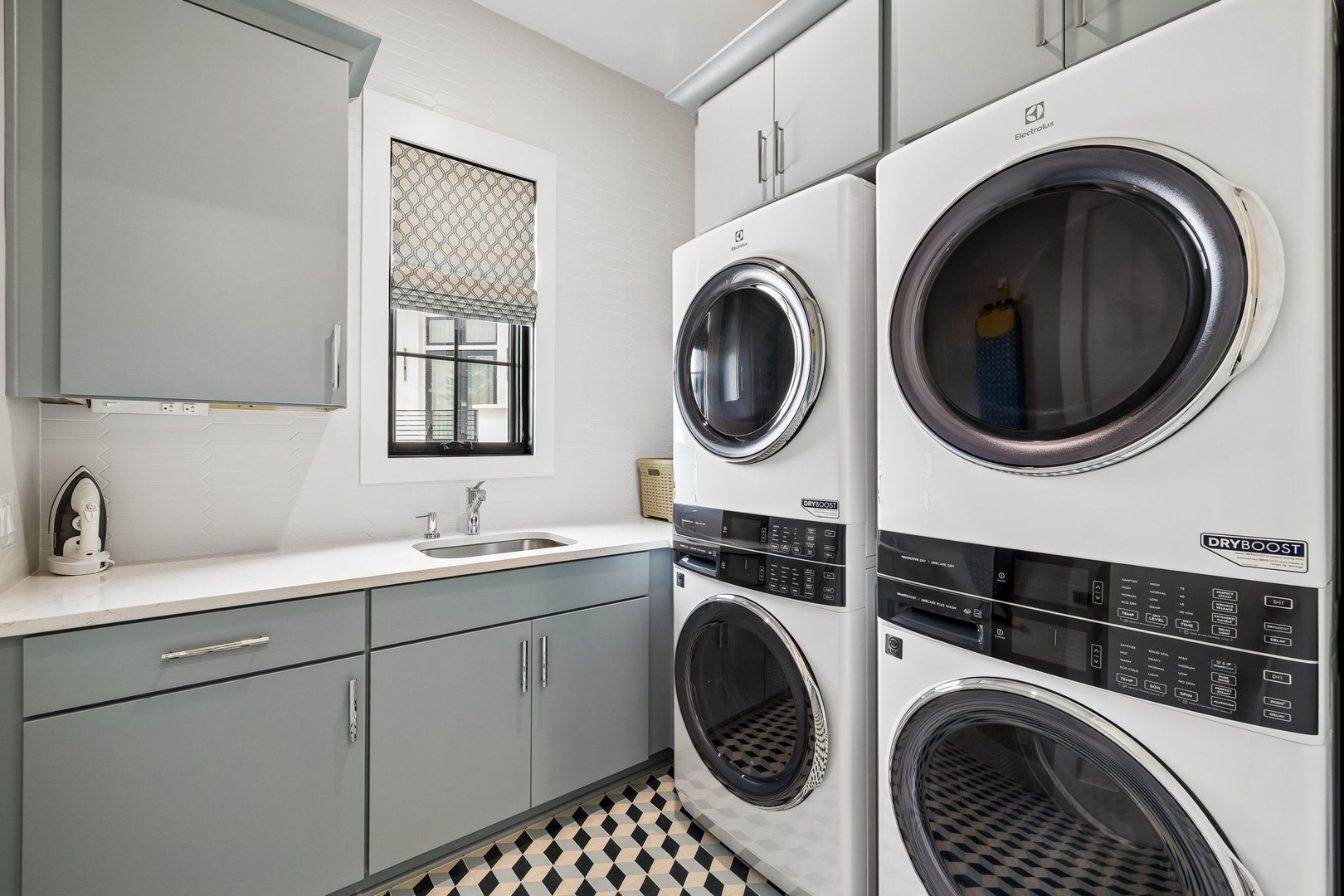 Your dedicated laundry room features dual front-loading washers and dryers, perfect for keeping your vacation wardrobe fresh. A convenient countertop and sink make hand-washing and folding a breeze.