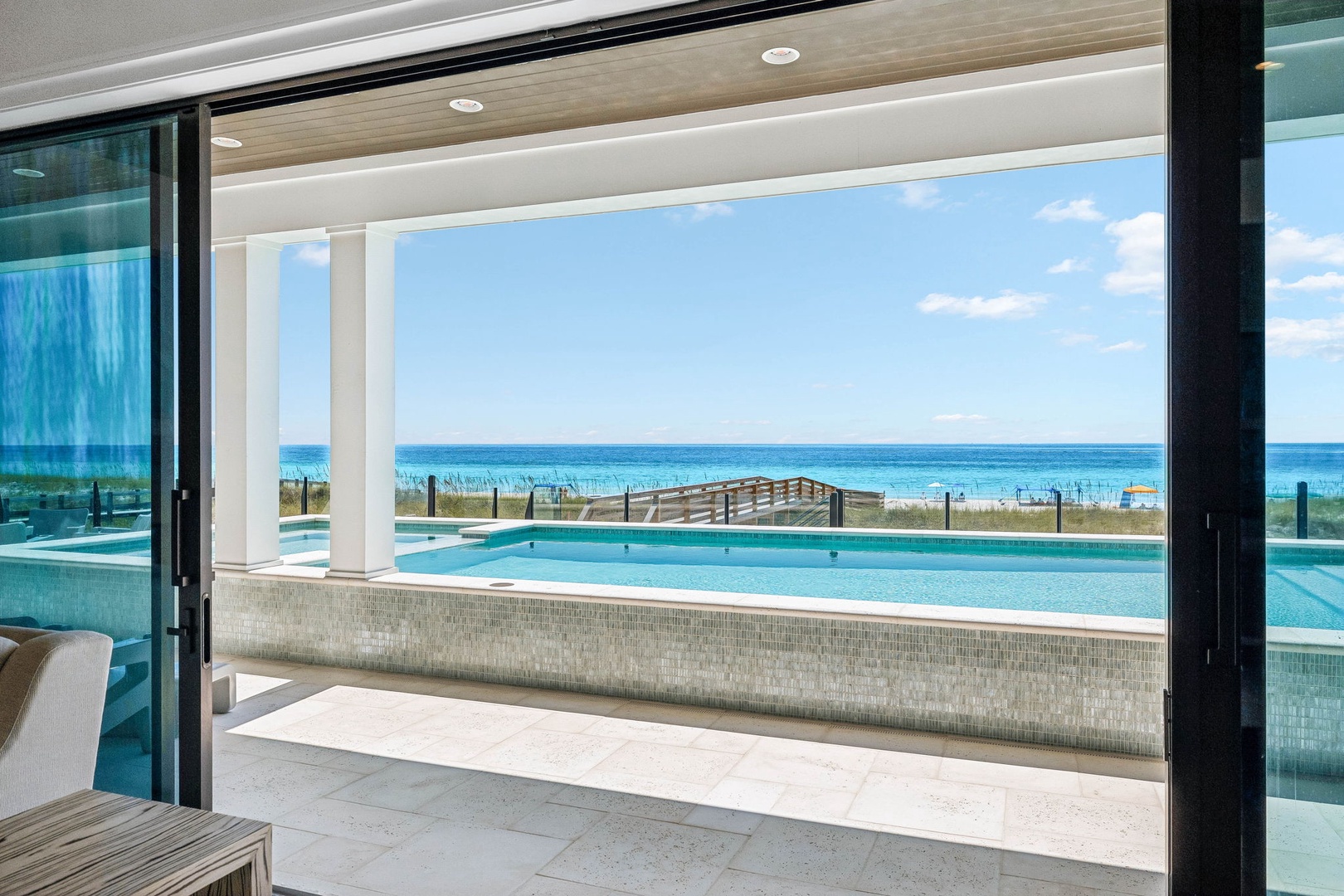 Step out to your private balcony and soak in sweeping views of the turquoise ocean and pristine beach beyond, with the shimmering pool just steps away.