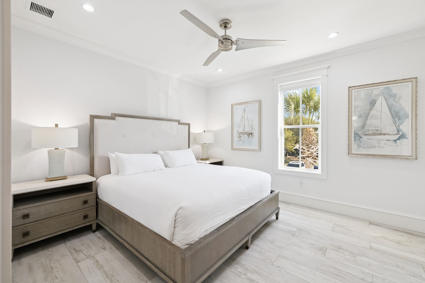 Drift into blissful sleep in your serene bedroom, featuring crisp linens and coastal artwork that creates the perfect tropical retreat.