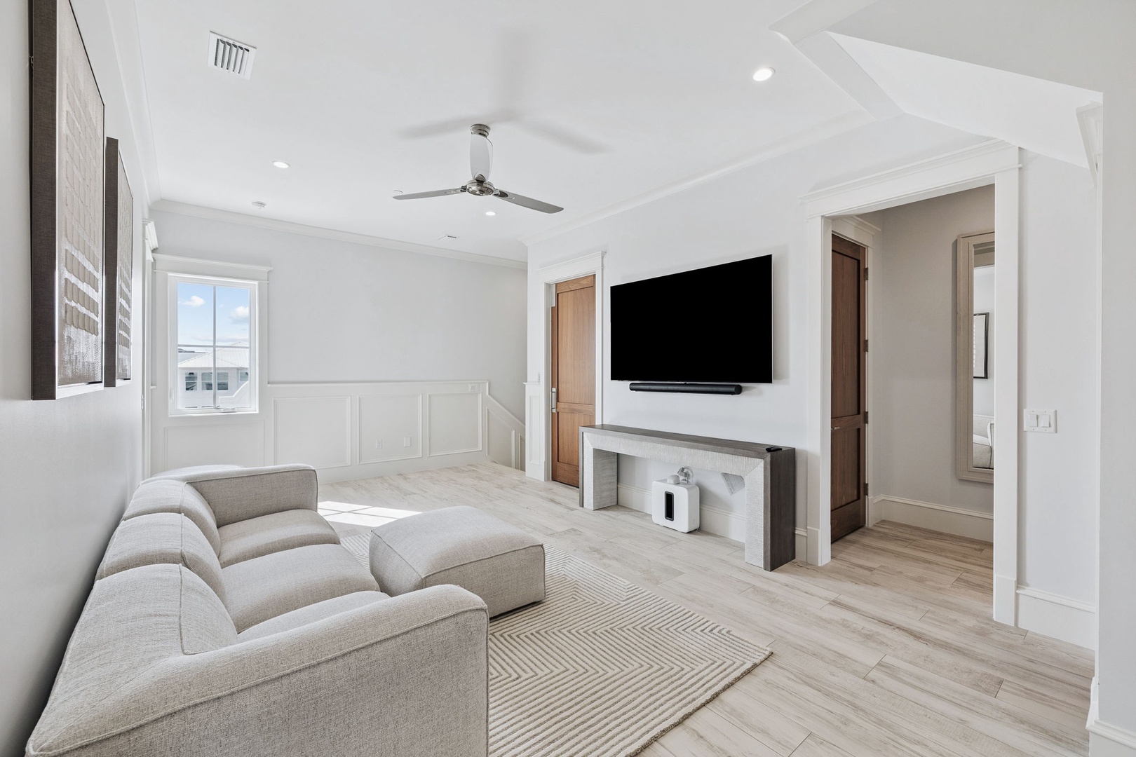 Settle into your elegant living room with plush seating, modern fireplace, and large TV for cozy evenings together.