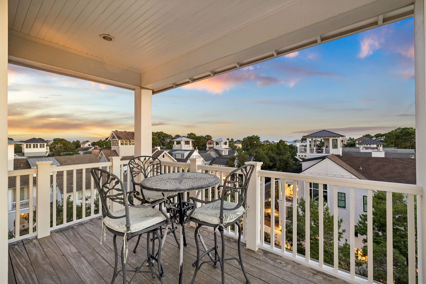 Sip your morning coffee or evening glass of wine at this charming bistro table while soaking in stunning neighborhood views and colorful sunset skies—your private perch for every memorable moment.