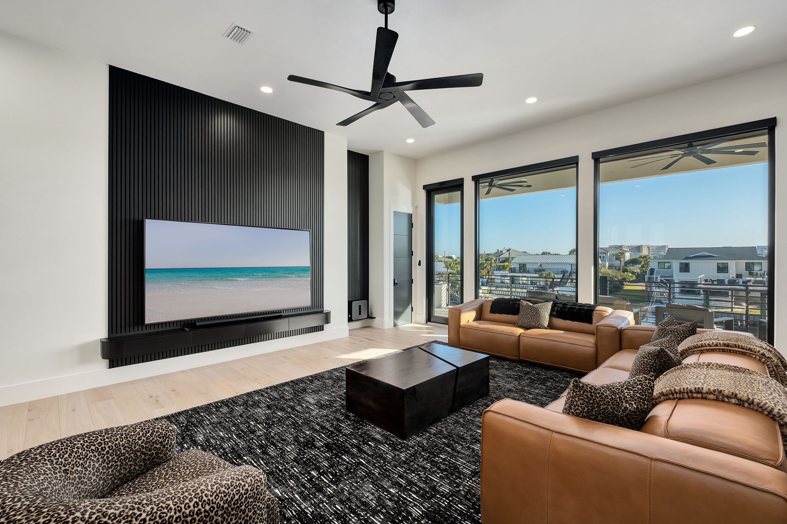 Sink into plush leather seating while enjoying your large-screen TV in this modern living space with stunning outdoor views.
