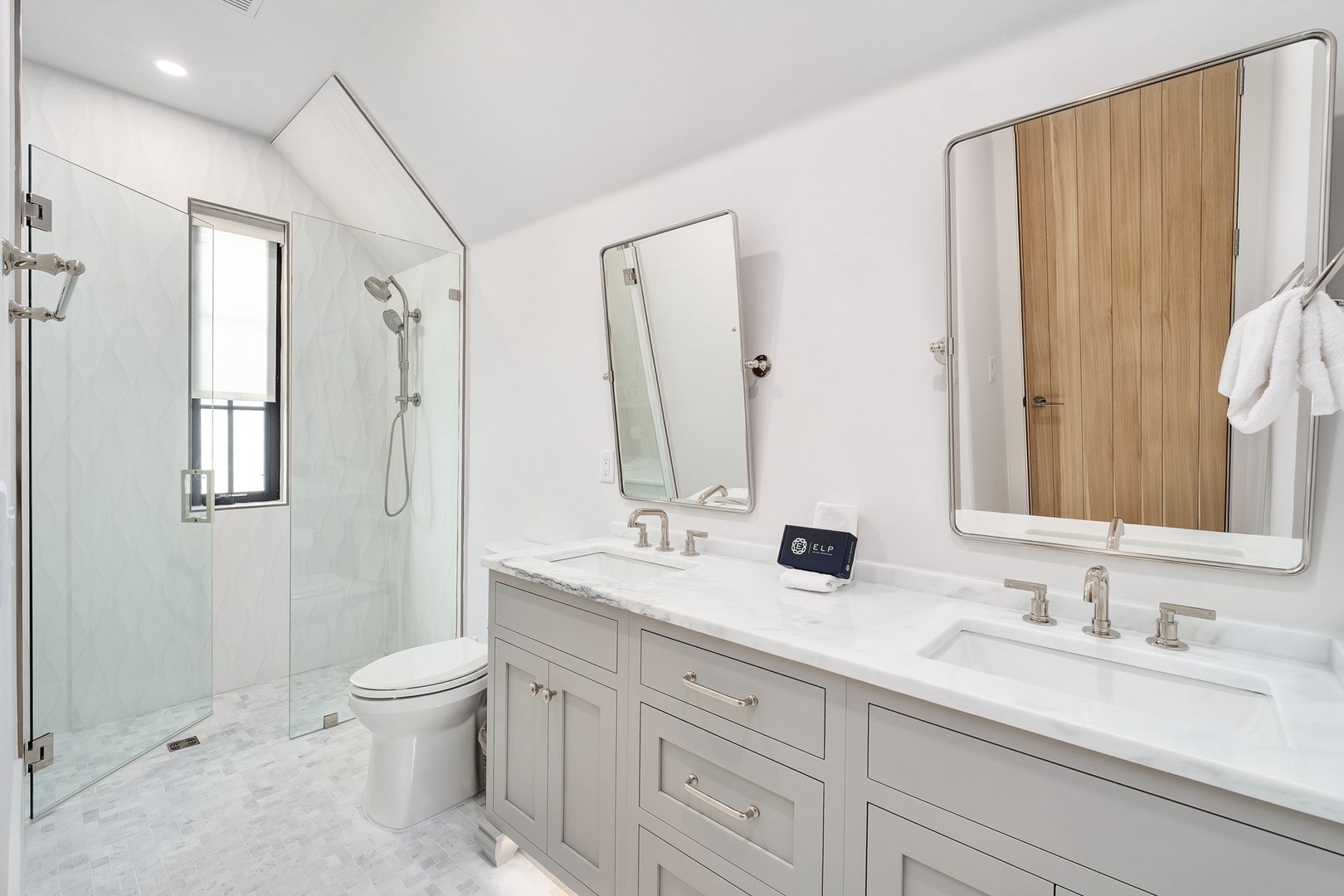 Step into your private spa-like retreat with dual vanities, marble countertops, and a luxurious walk-in shower.