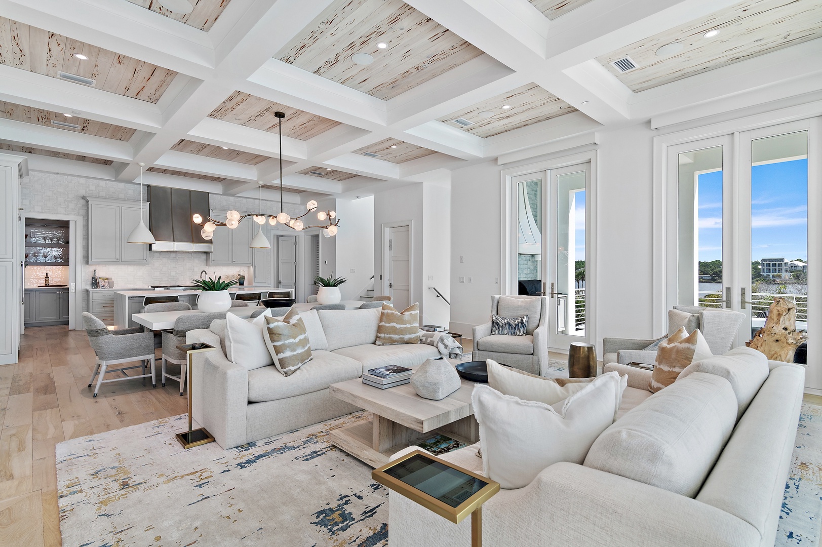 Bright coastal living with soaring beam ceilings and waterfront views. You'll love the open flow from living room to kitchen, plush seating, and airy natural light.