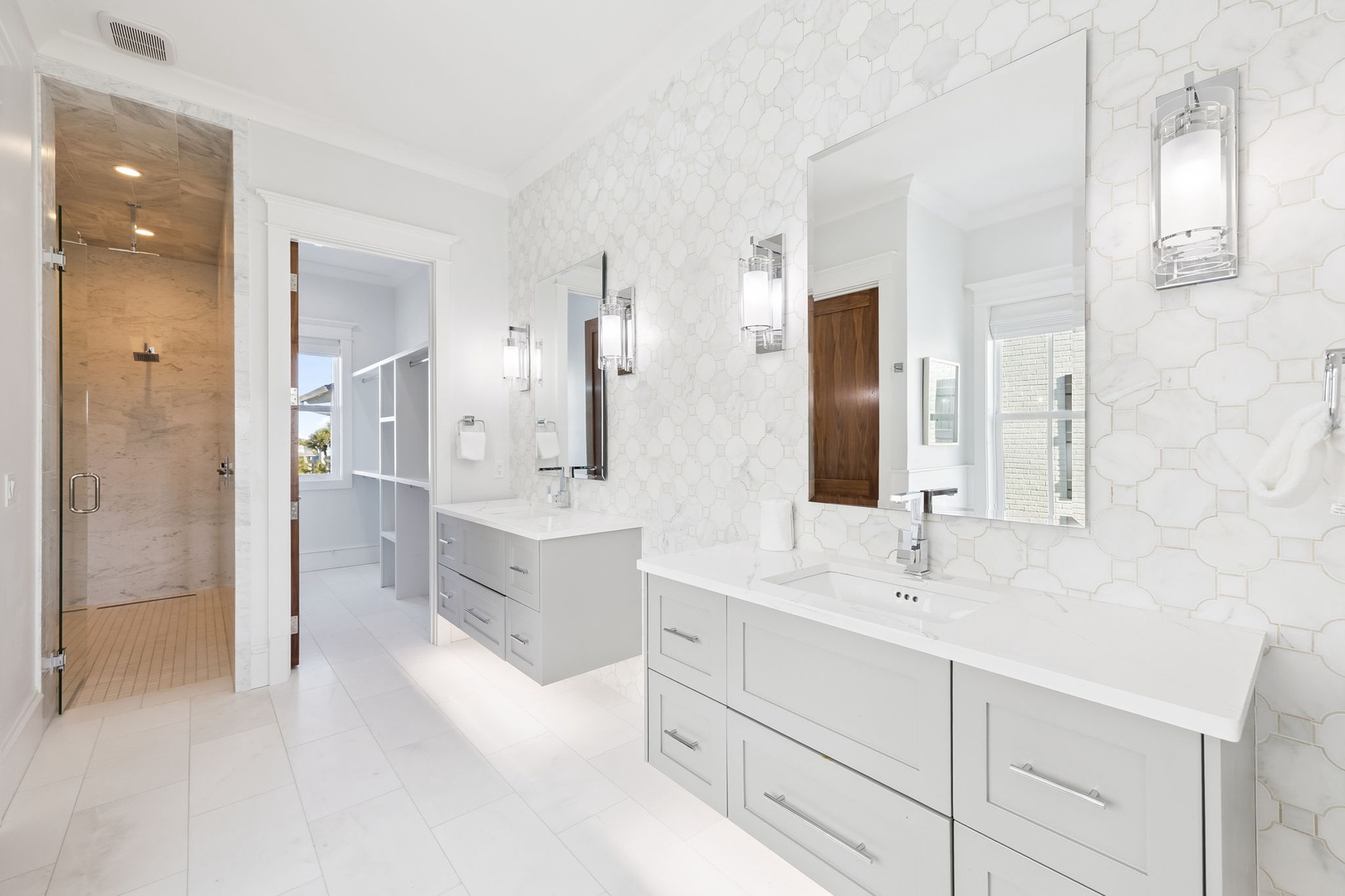 Your spacious master bathroom features dual vanities, elegant marble accents, and a luxurious walk-in shower for ultimate relaxation.